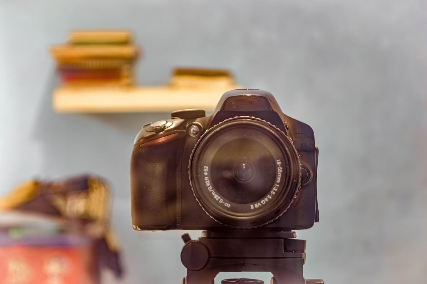 a black DSLR camera mounted on a tripod photo