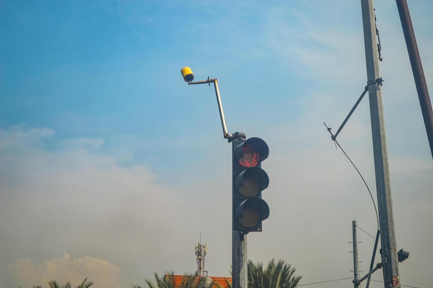 a traffic light equipped with a CCTV camera photo