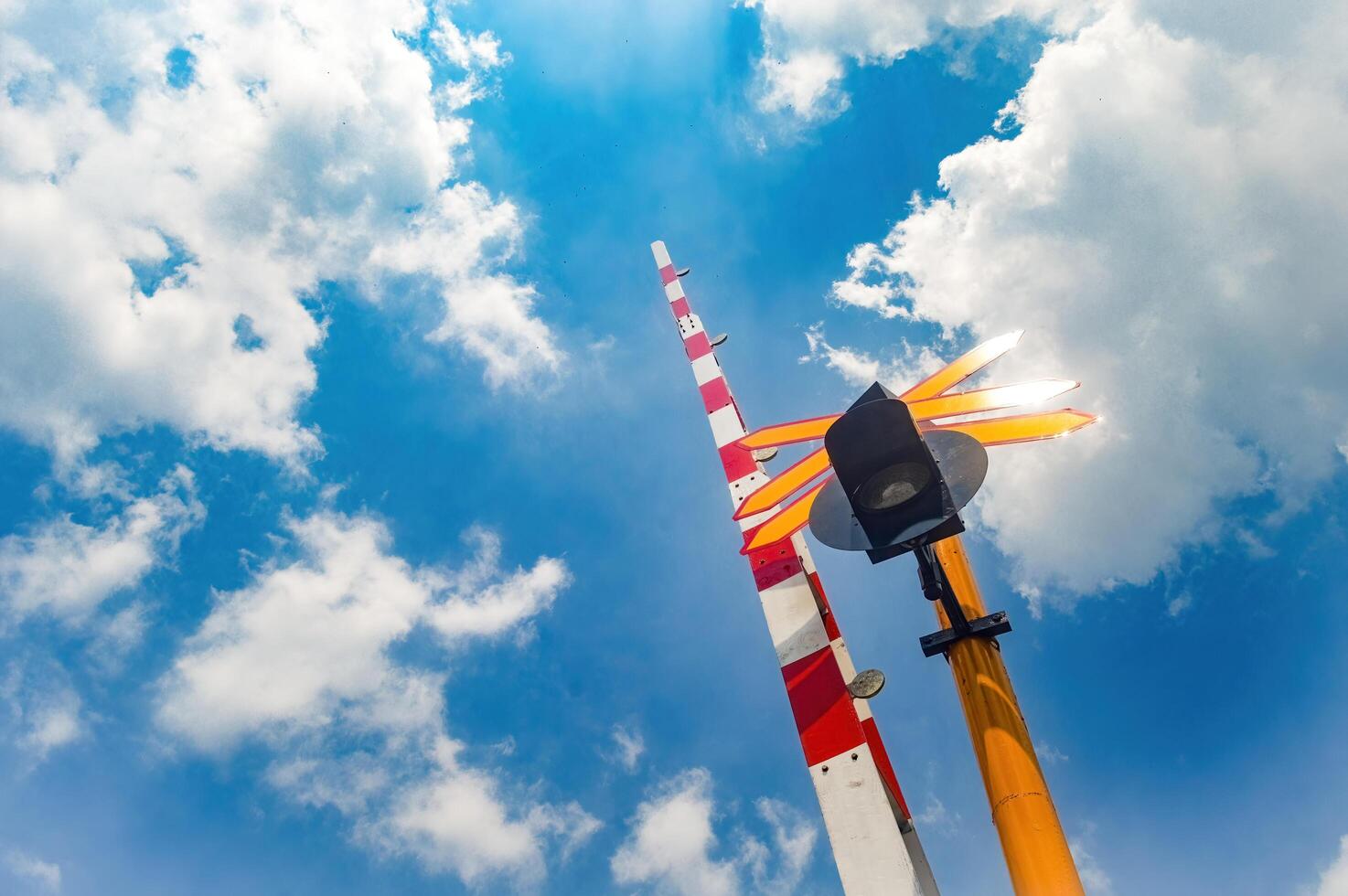 railway crossing gates with signs and sirens in Indonesia photo