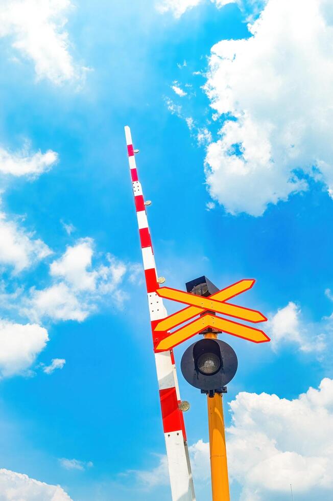 railway crossing gates with signs and sirens in Indonesia photo