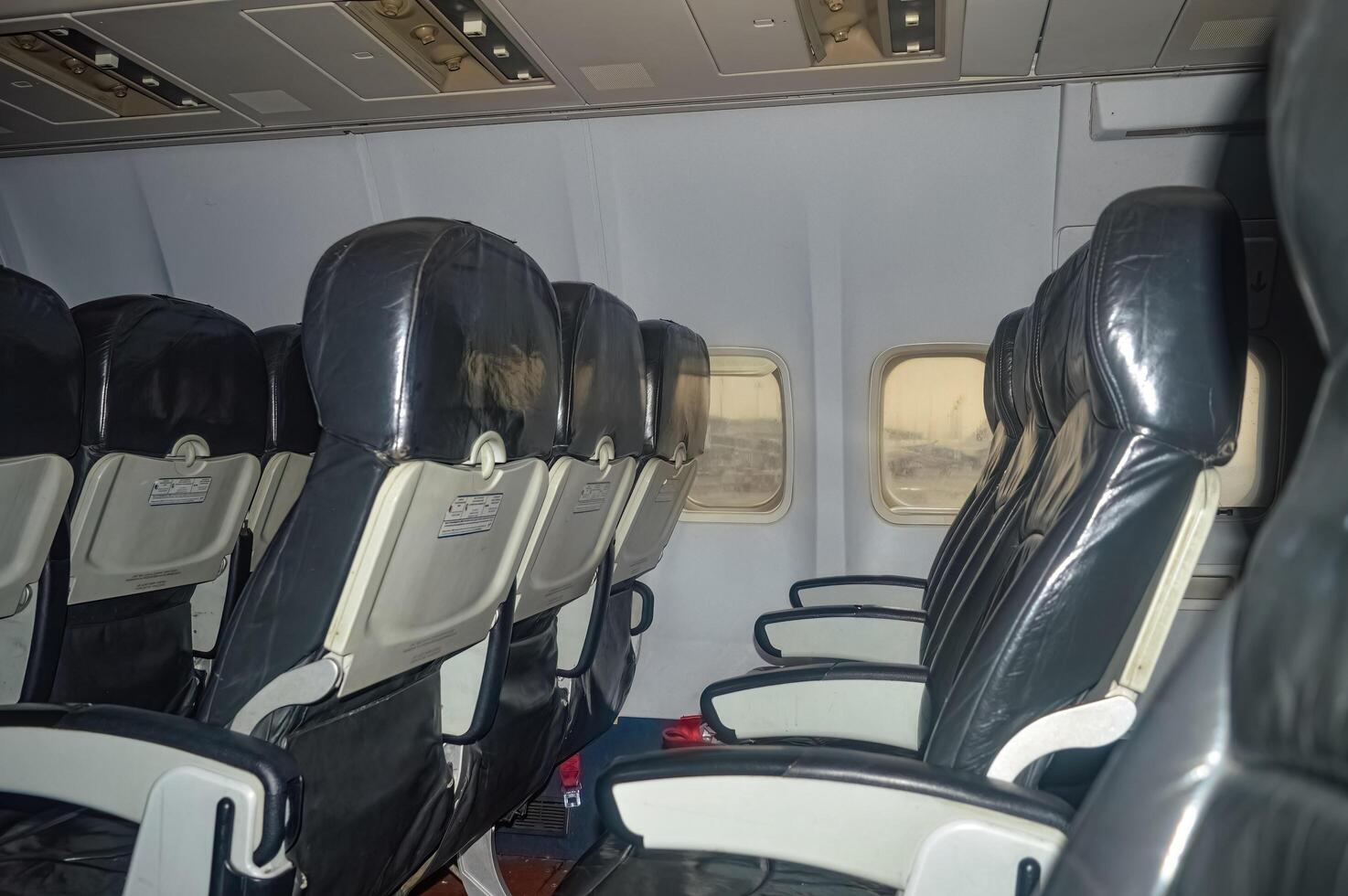 The interior of a narrow body aircraft complete with seats photo