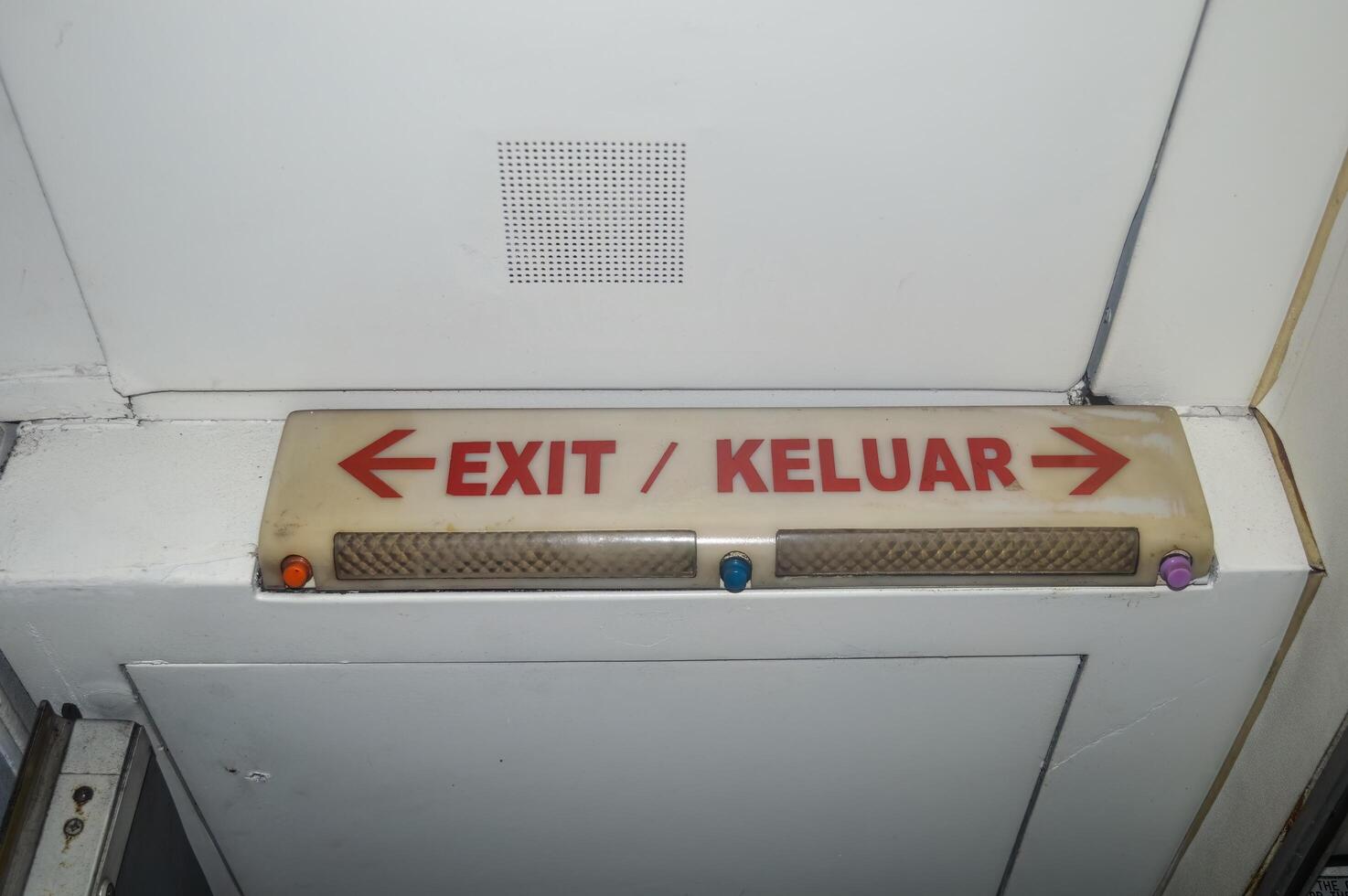 exit sign on the aircraft door corridor photo