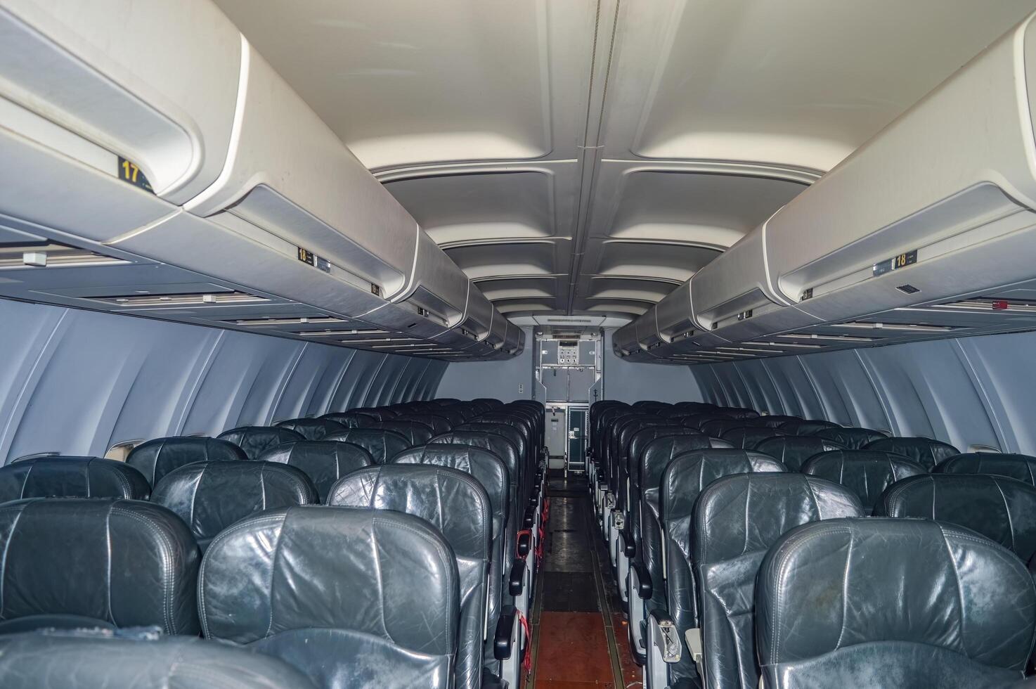 The interior of a narrow body aircraft complete with seats photo