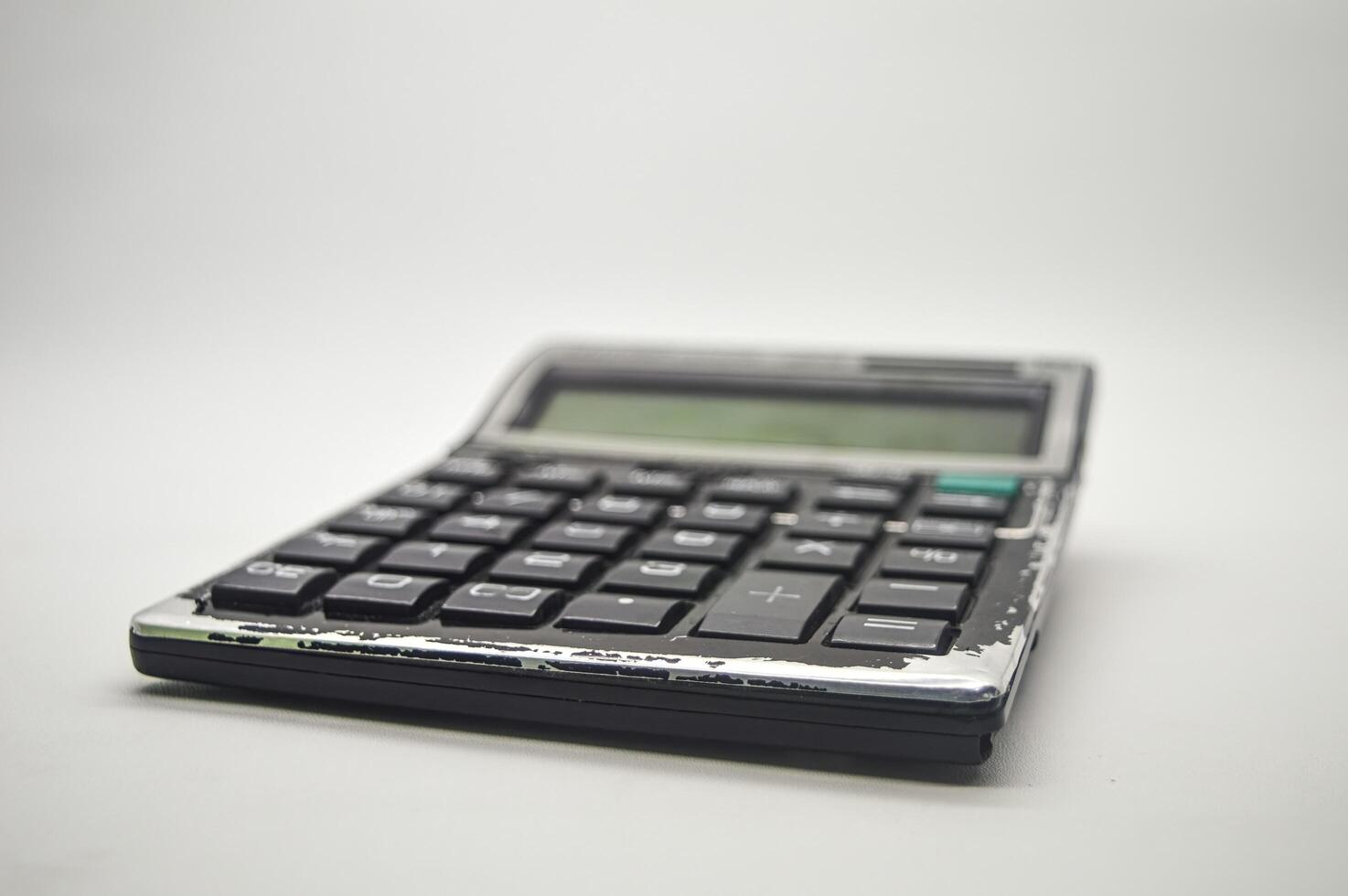 a black calculator isolated on white background. perfect for Education, mathematics, and Business Article or Content. photo