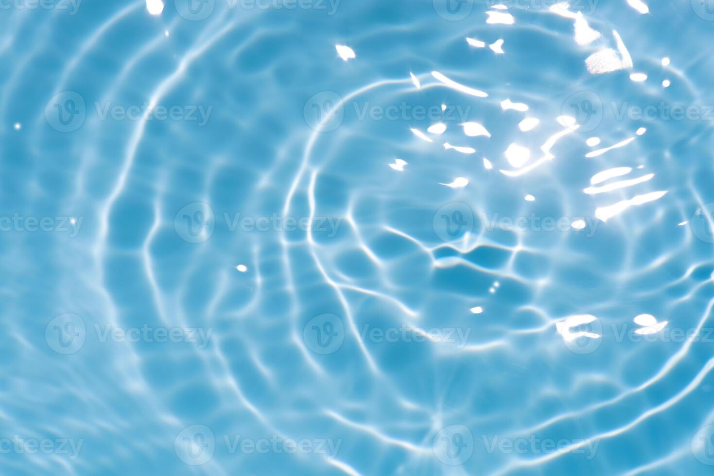 Bluewater waves on the surface ripples blurred. Defocus blurred transparent blue colored clear calm water surface texture with splash and bubbles. Water waves with shining pattern texture background. photo