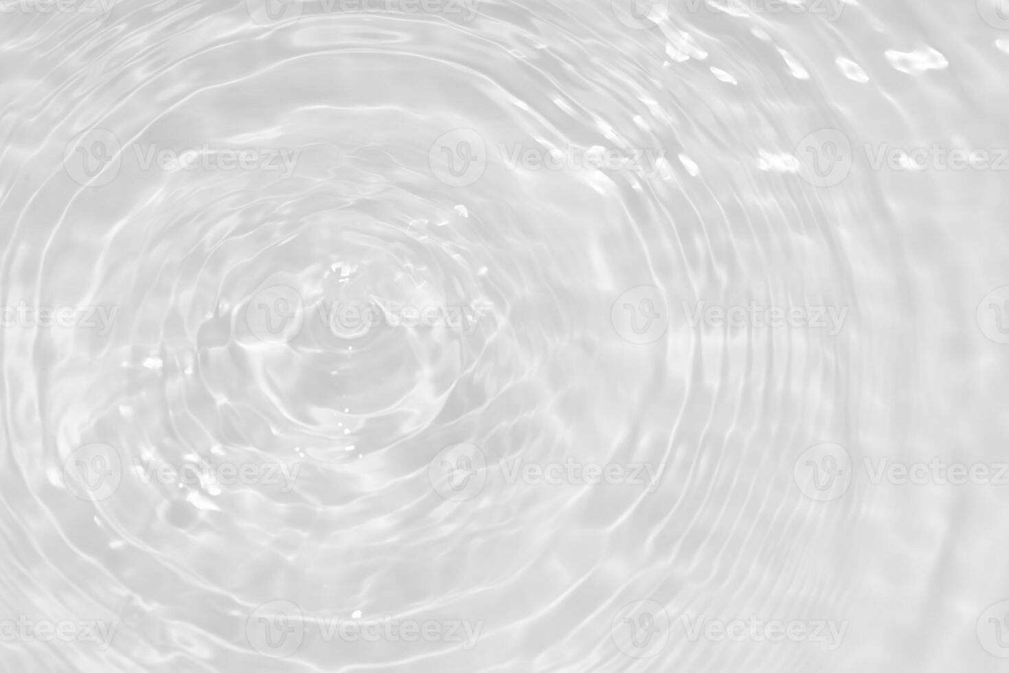 Bluewater waves on the surface ripples blurred. Defocus blurred transparent blue colored clear calm water surface texture with splash and bubbles. Water waves with shining pattern texture background. photo