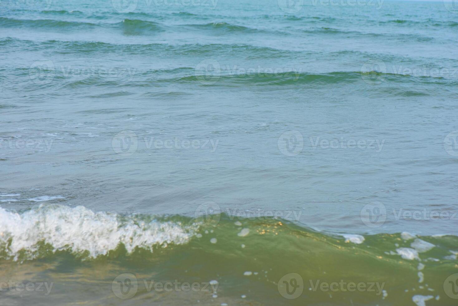 Bluewater waves on the surface ripples blurred. Defocus blurred transparent blue colored clear calm water surface texture with splash and bubbles. Water waves with shining pattern texture background. photo