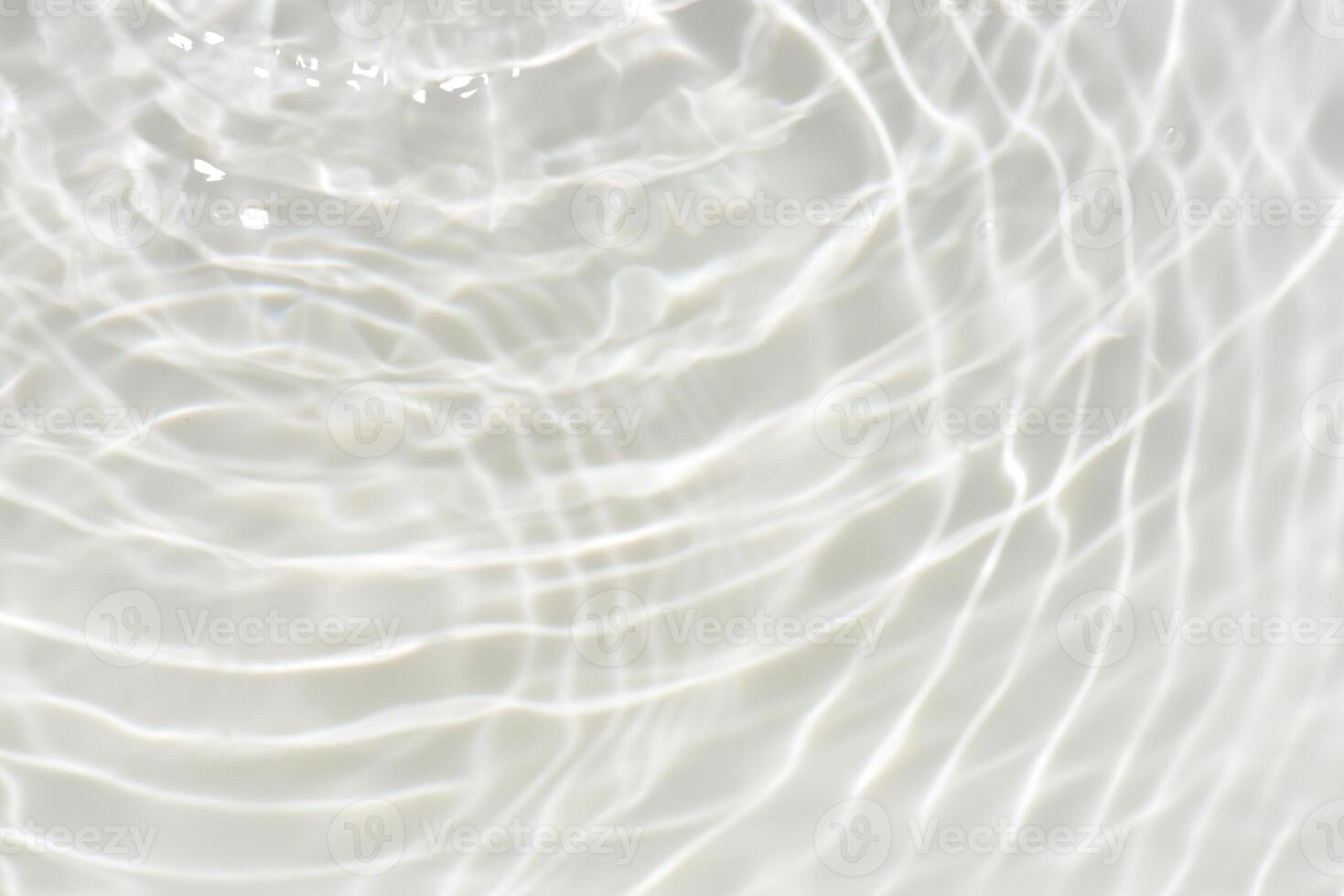 Bluewater waves on the surface ripples blurred. Defocus blurred transparent blue colored clear calm water surface texture with splash and bubbles. Water waves with shining pattern texture background. photo