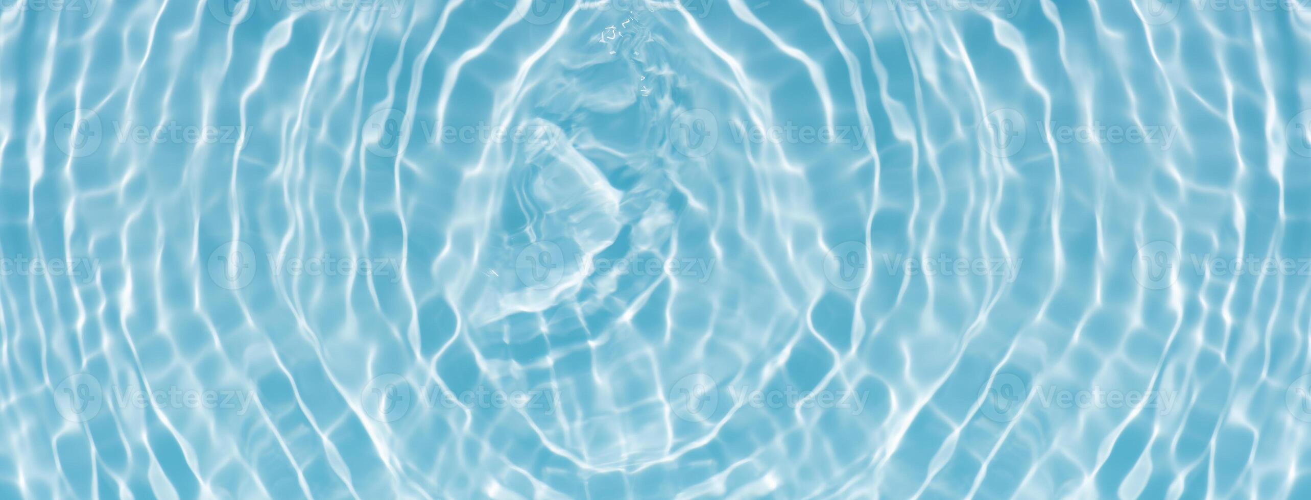 Bluewater waves on the surface ripples blurred. Defocus blurred transparent blue colored clear calm water surface texture with splash and bubbles. Water waves with shining pattern texture background. photo