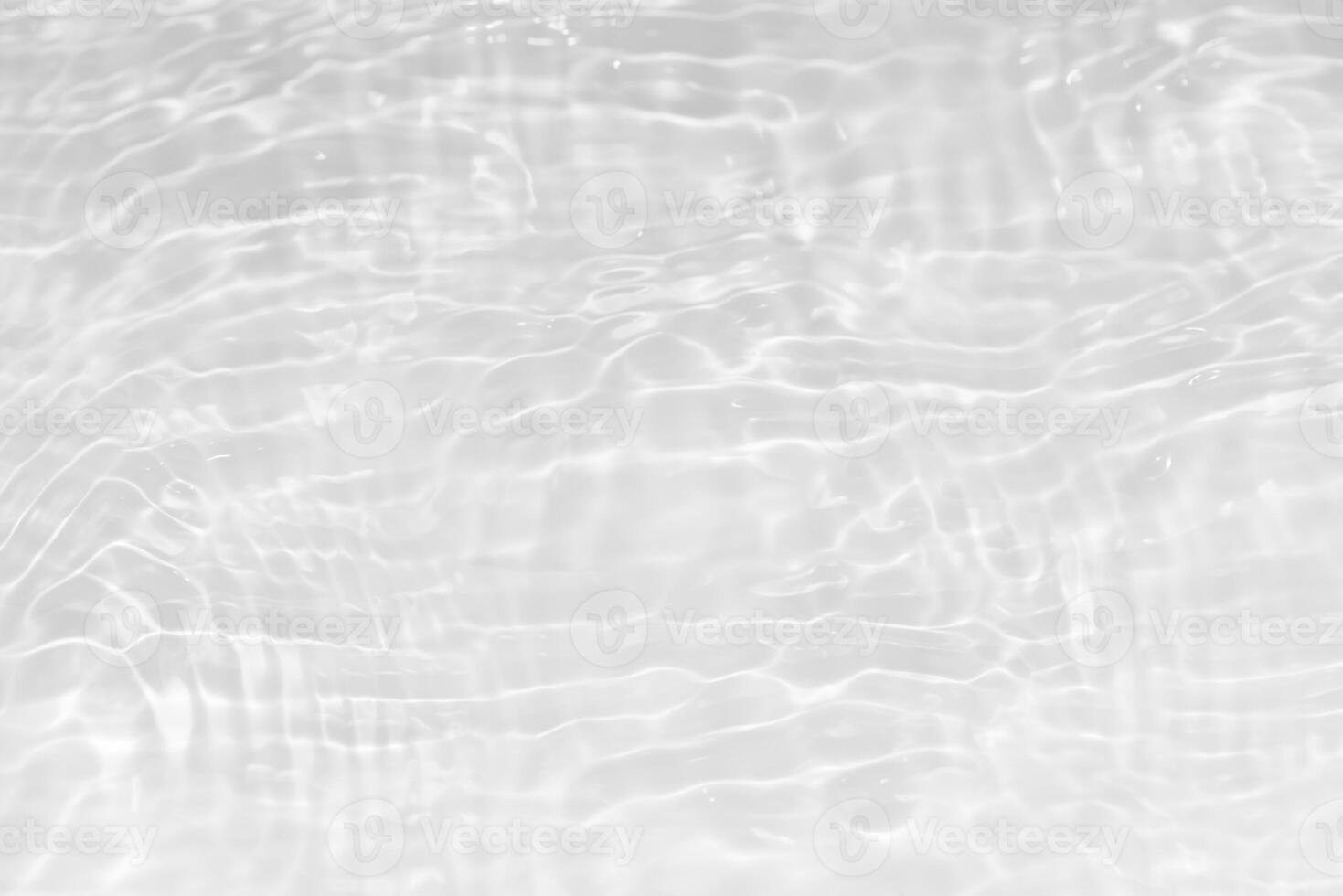 Bluewater waves on the surface ripples blurred. Defocus blurred transparent blue colored clear calm water surface texture with splash and bubbles. Water waves with shining pattern texture background. photo