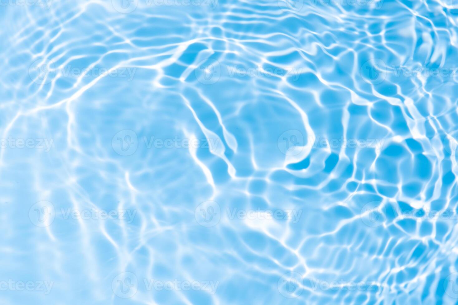 Bluewater waves on the surface ripples blurred. Defocus blurred transparent blue colored clear calm water surface texture with splash and bubbles. Water waves with shining pattern texture background. photo