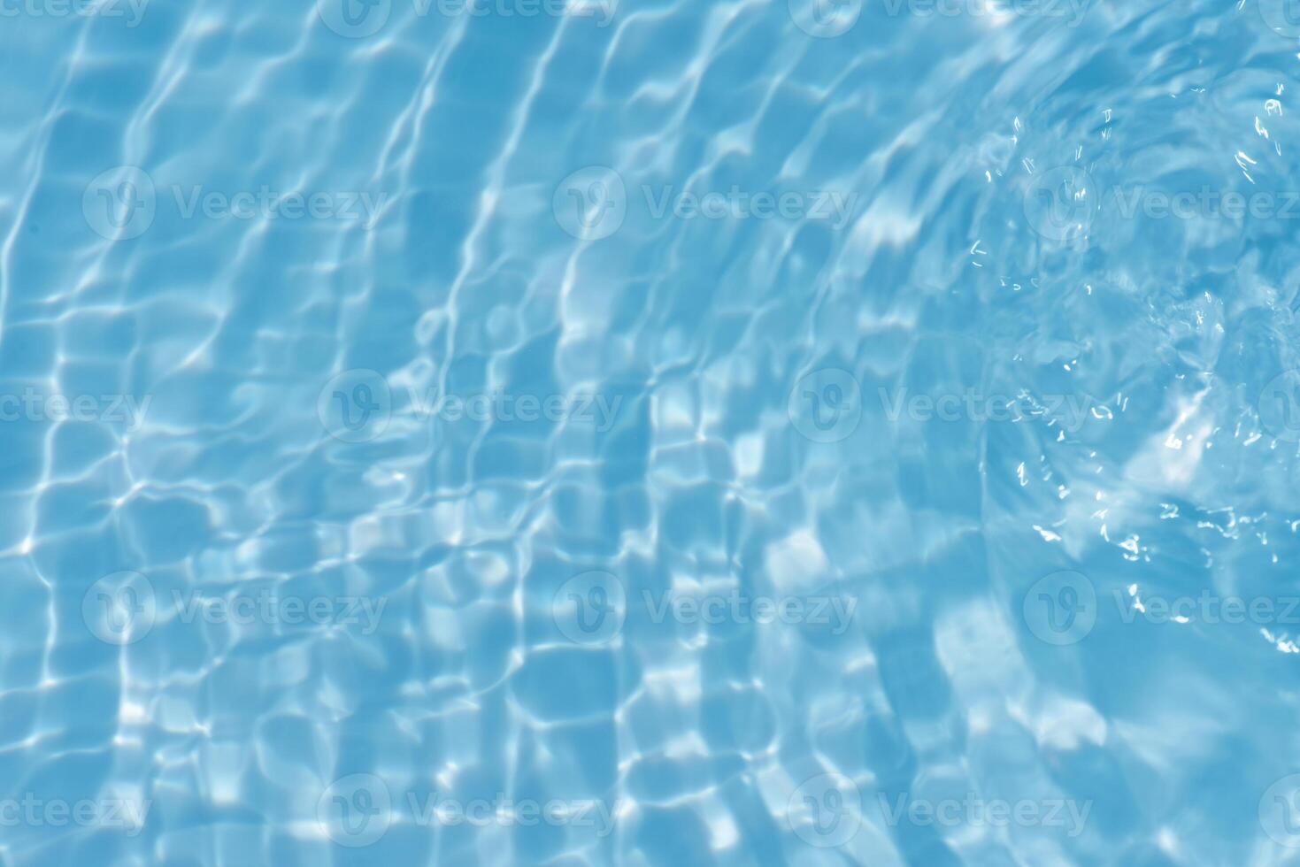 Bluewater waves on the surface ripples blurred. Defocus blurred transparent blue colored clear calm water surface texture with splash and bubbles. Water waves with shining pattern texture background. photo