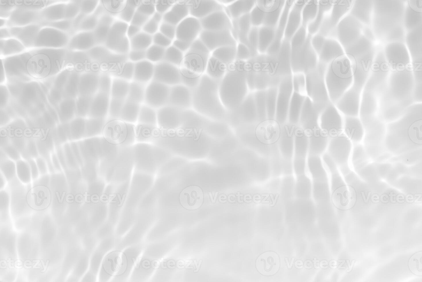 Bluewater waves on the surface ripples blurred. Defocus blurred transparent blue colored clear calm water surface texture with splash and bubbles. Water waves with shining pattern texture background. photo