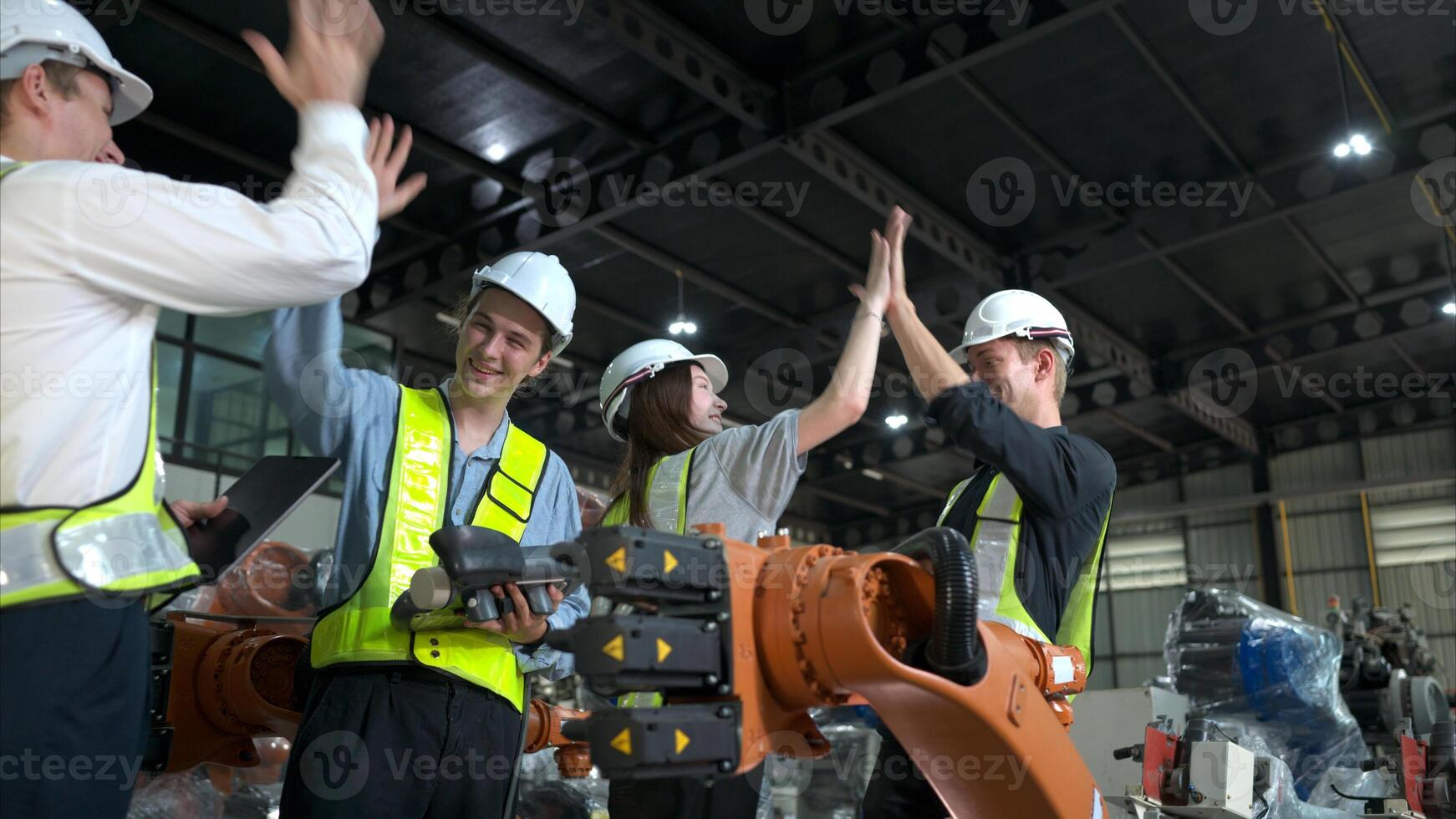 Group of engineers and technicians working together in a robotic arm factory. Inspecting robot arm before delivering to customers photo