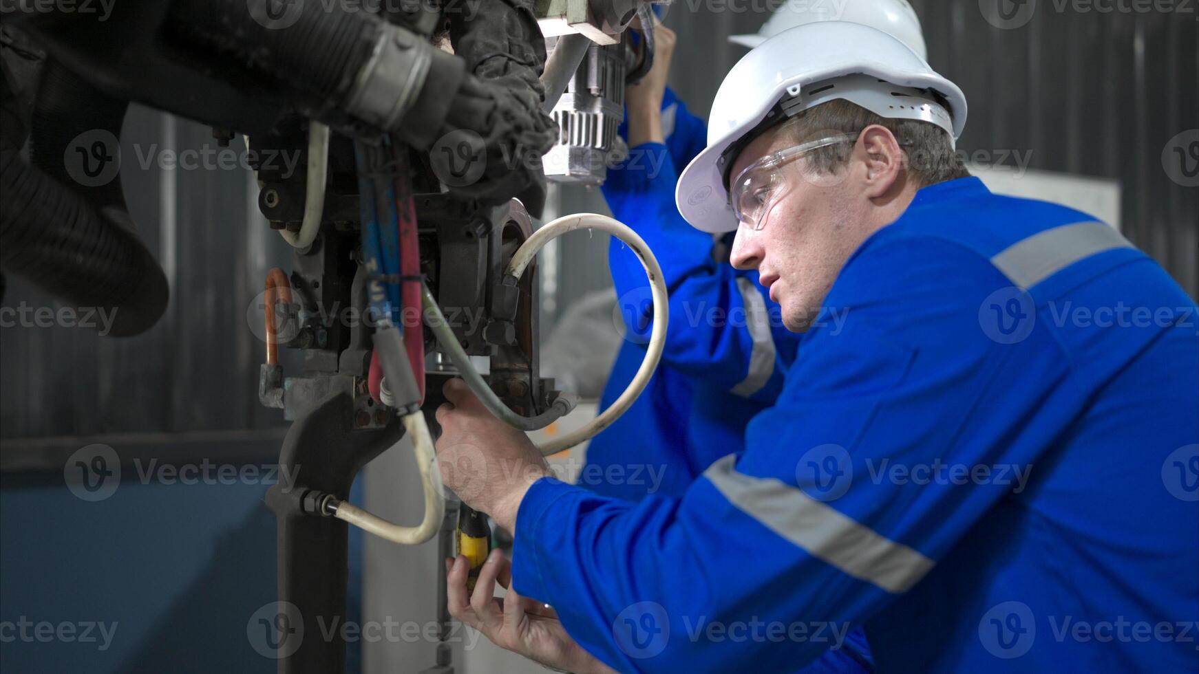 ambos de ingenieros trabajando juntos en un robótico brazo fábrica, robótico brazo industria y Ingenieria concepto. foto