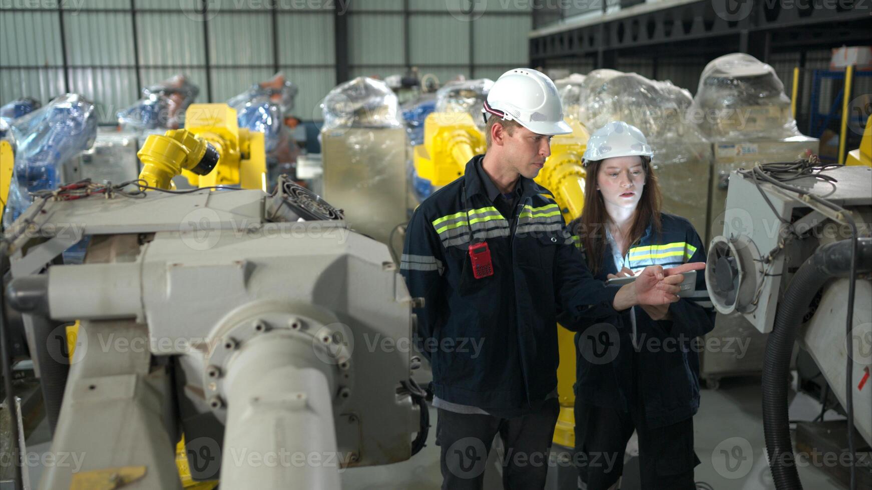 Both of engineers working together in a robotic arm factory, Robotic arm industry and engineering concept. photo