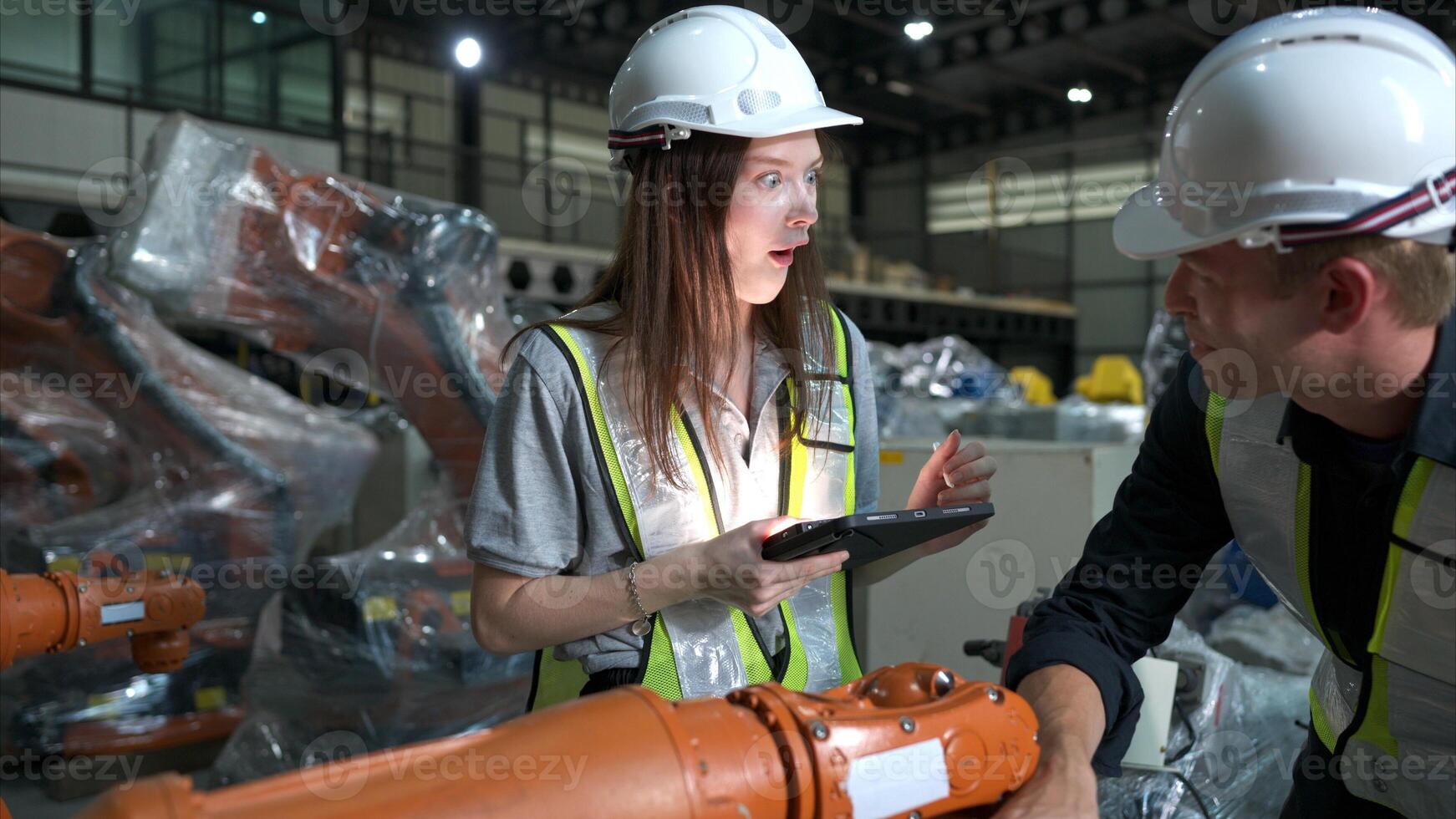 Both of engineers working together in a robotic arm factory, Robotic arm industry and engineering concept. photo