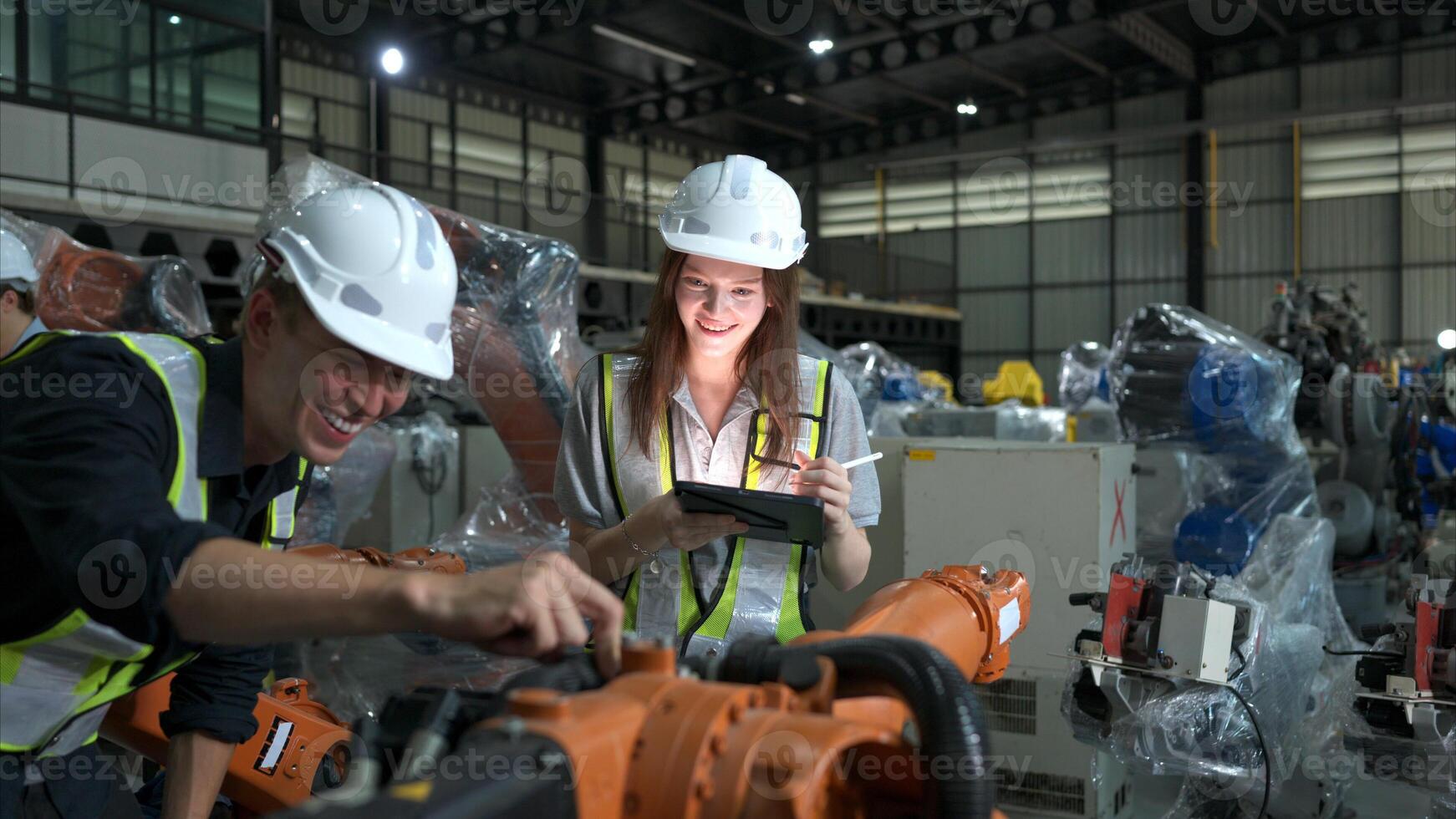 Both of engineers working together in a robotic arm factory, Robotic arm industry and engineering concept. photo