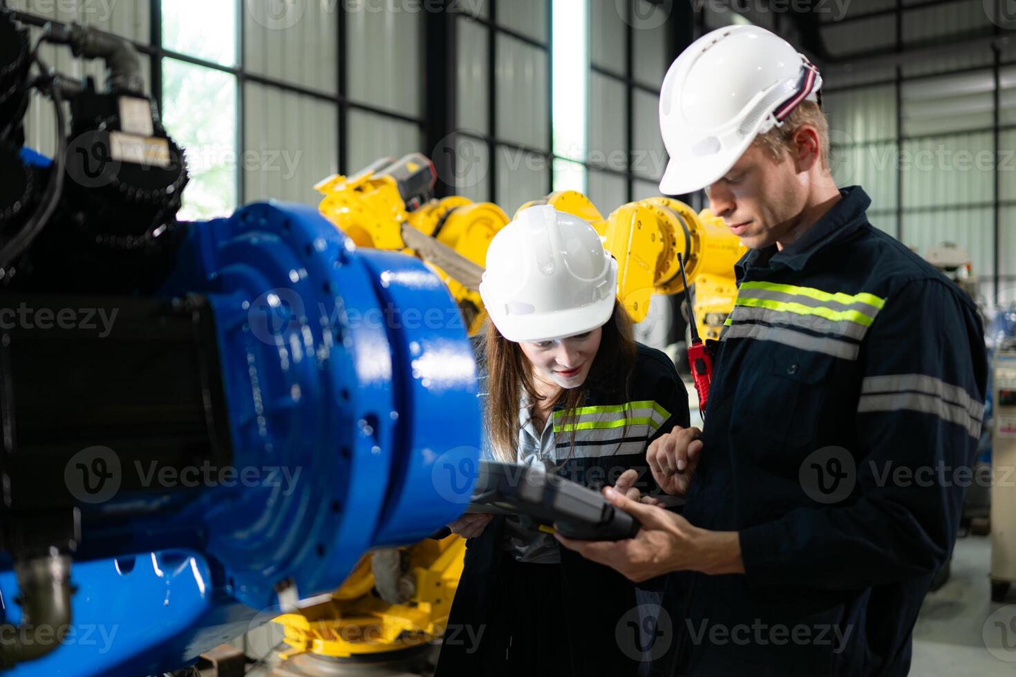 Both of engineers working together in a robotic arm factory, Robotic arm industry and engineering concept. photo