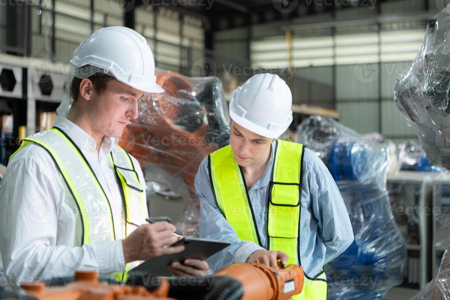 Both of engineers working together in a robotic arm factory, Robotic arm industry and engineering concept. photo