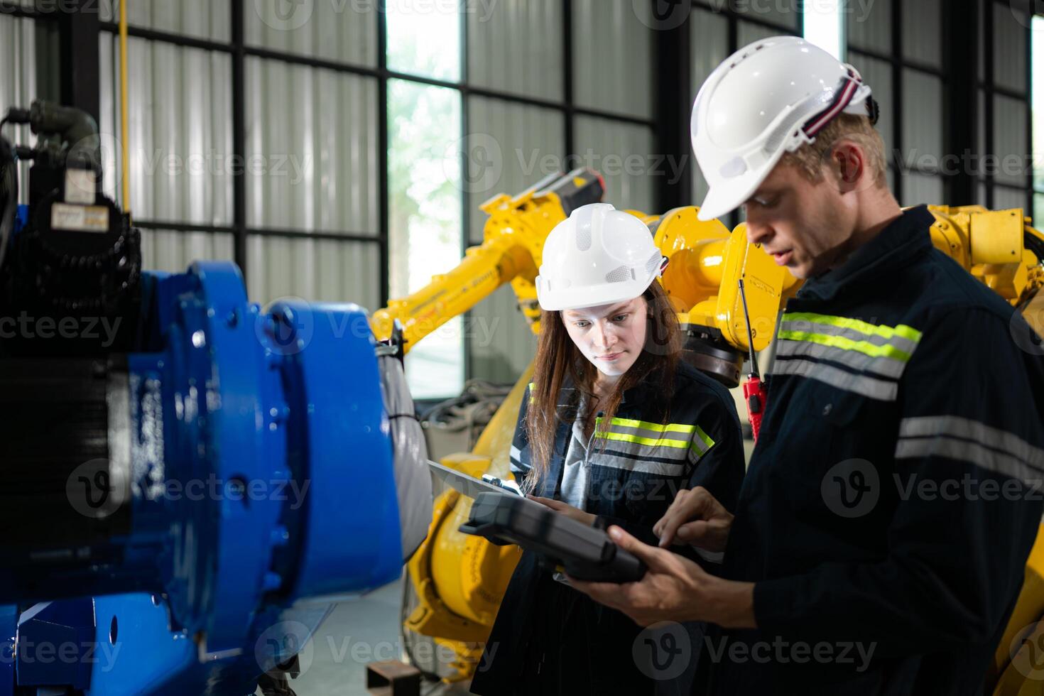 Both of engineers working together in a robotic arm factory, Robotic arm industry and engineering concept. photo