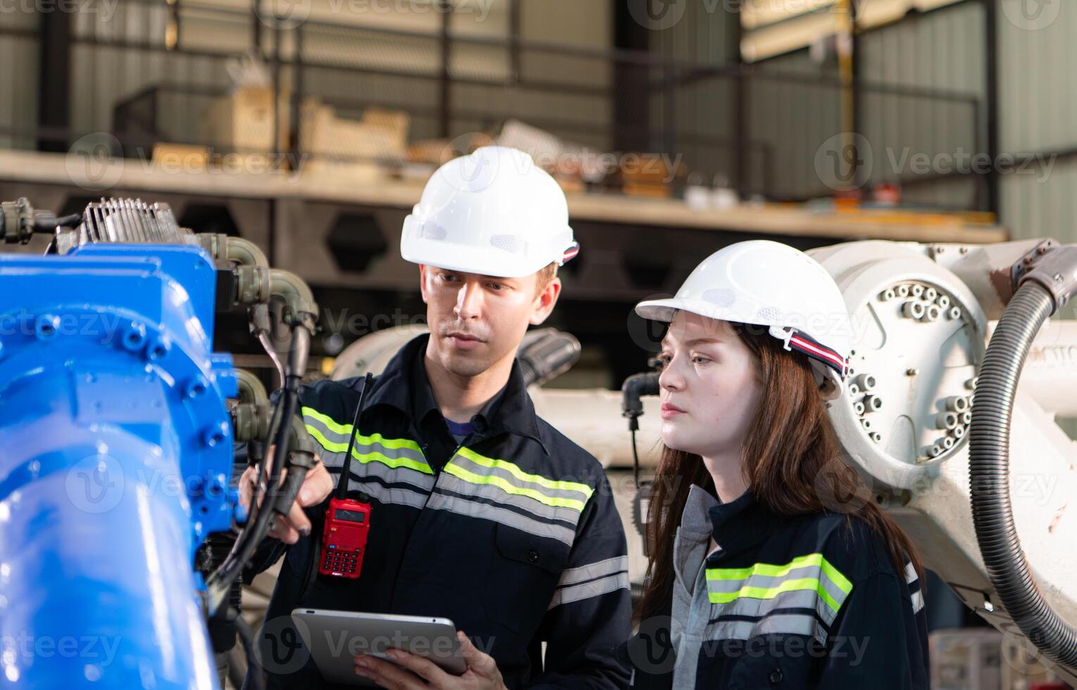 Both of engineers working together in a robotic arm factory, Robotic arm industry and engineering concept. photo