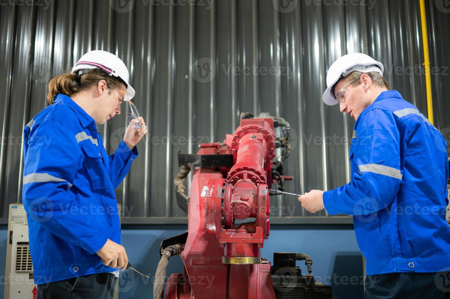 Both of engineers working together in a robotic arm factory, Robotic arm industry and engineering concept. photo