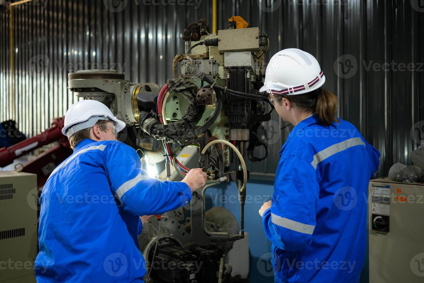 Both of engineers working together in a robotic arm factory, Robotic arm industry and engineering concept. photo