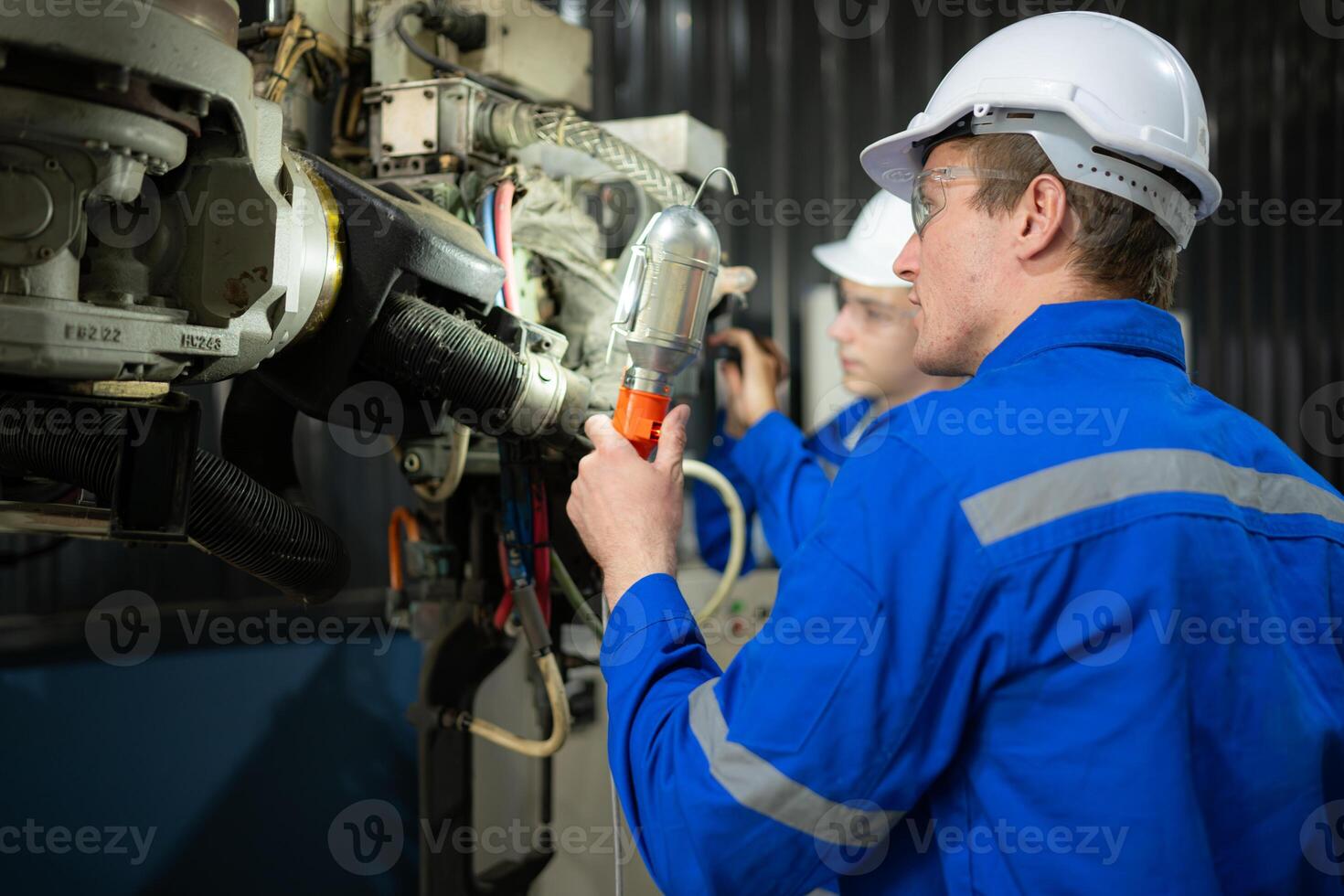 Both of engineers working together in a robotic arm factory, Robotic arm industry and engineering concept. photo