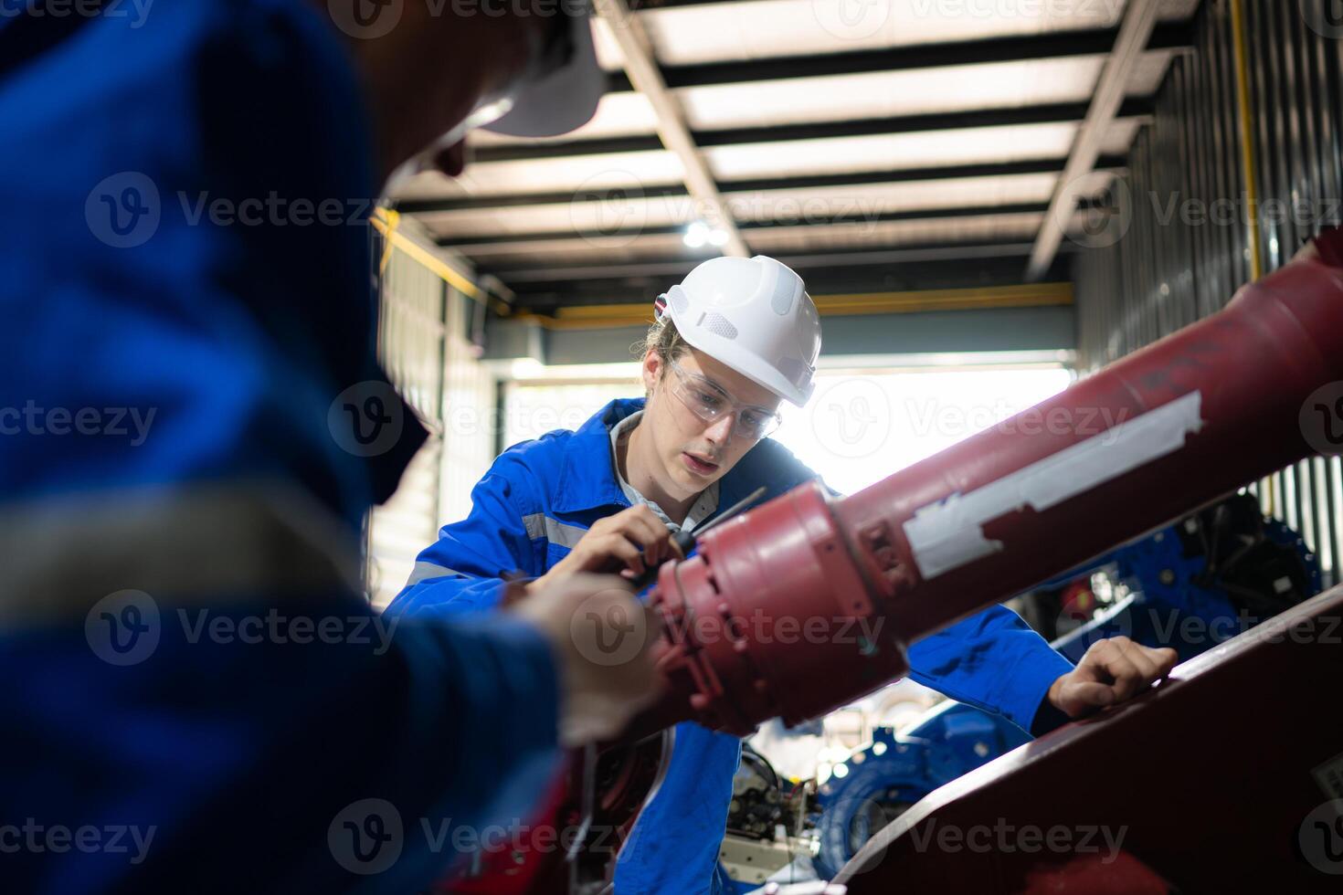 Both of engineers working together in a robotic arm factory, Robotic arm industry and engineering concept. photo