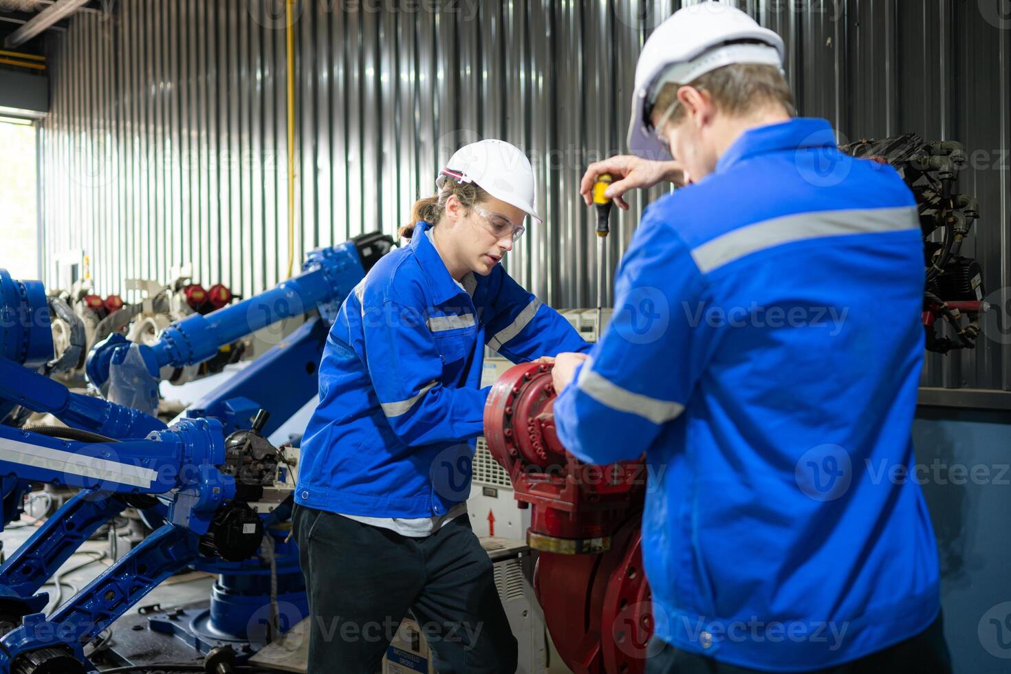 Both of engineers working together in a robotic arm factory, Robotic arm industry and engineering concept. photo