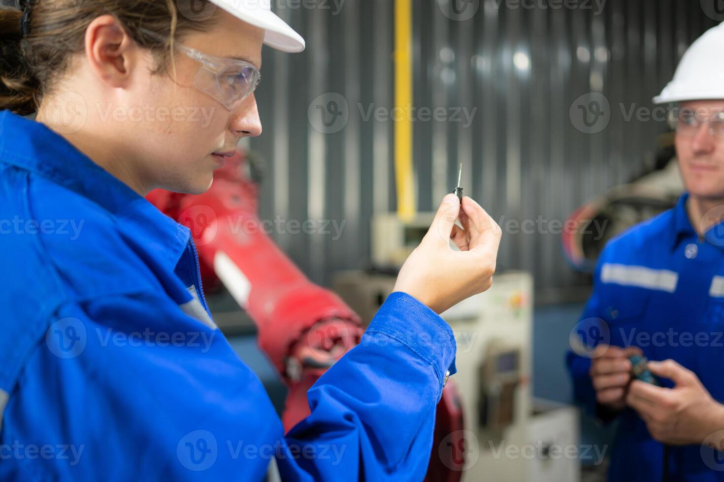 Engineers and technicians working together in a robotic arm factory. Check the electronic spare parts and electrical system of the robotic arm. photo