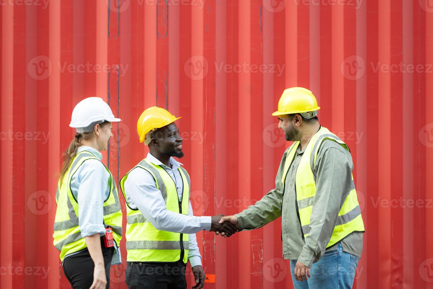 Group of workers in a container storage yard greeting each other during breaks in front of container warehouse, photo