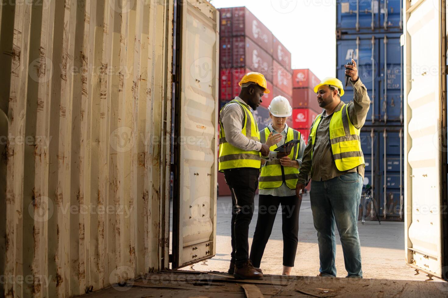 Group of workers in an empty container storage yard, The condition of the old container is being assessed to determine whether it requires maintenance for usage. photo