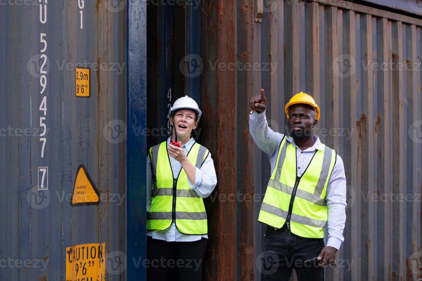 Both of engineers working in the container yard. This is a freight transportation and distribution warehouse. photo