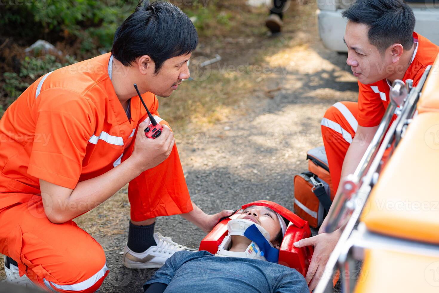 el paramédico es ayudando un lesionado hombre en un emergencia situación en el la carretera. foto