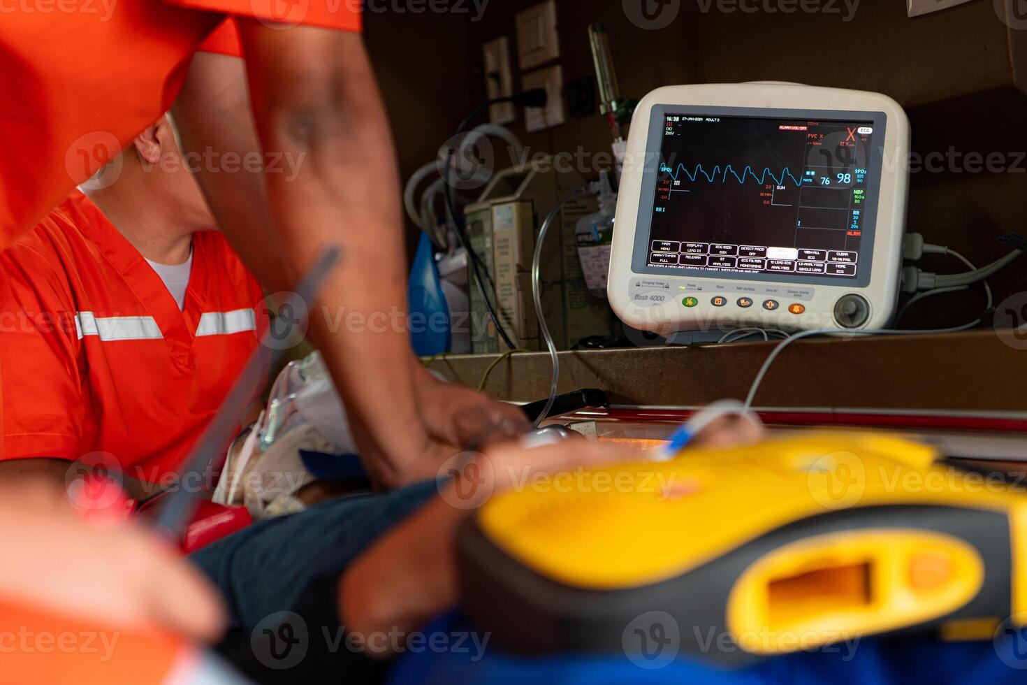 The rescue team is administering CPR to a patient who was involved in an ambulance accident. photo