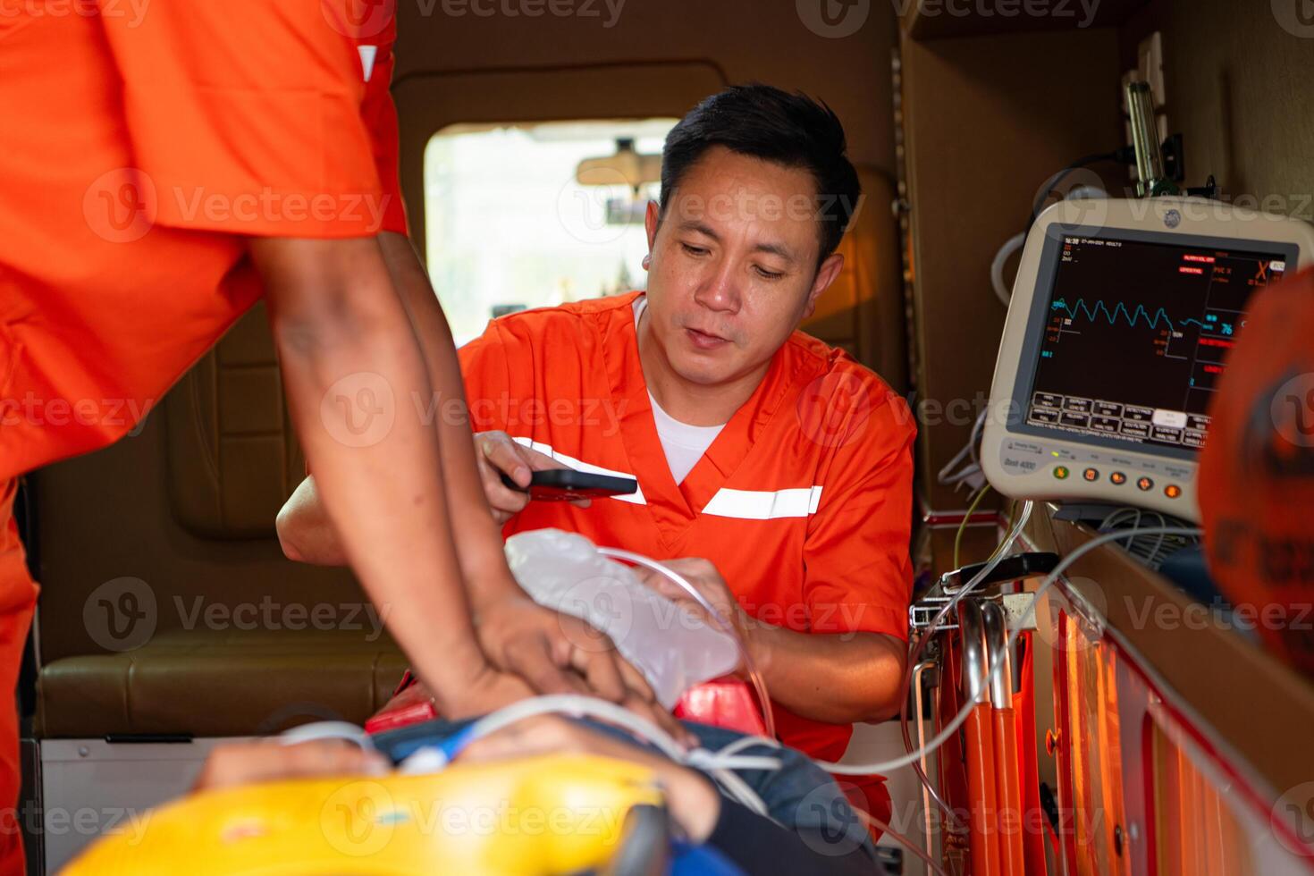 The rescue team is administering CPR to a patient who was involved in an ambulance accident. photo