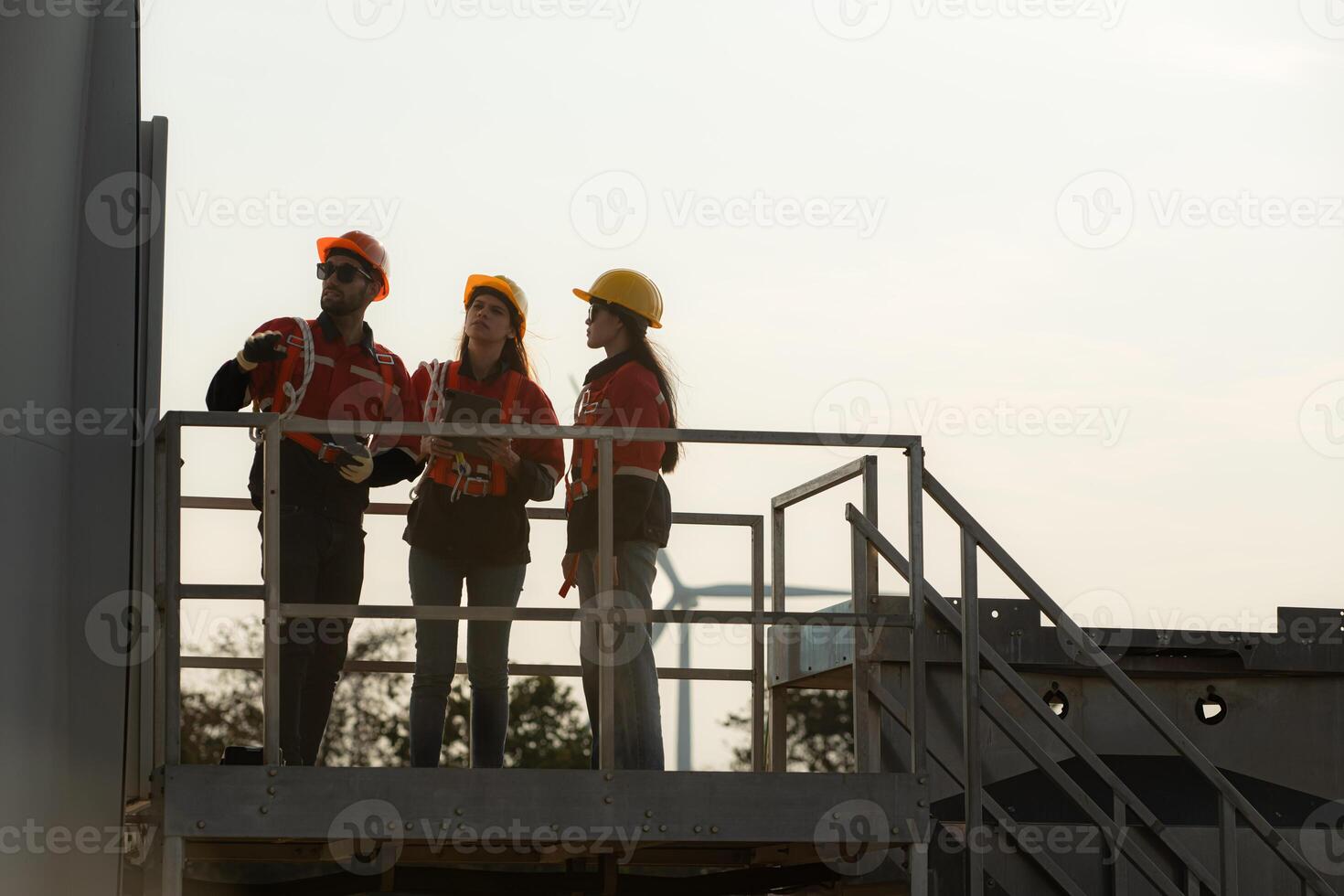 A group of engineers and architects work in floor of base ground of a wind turbine photo