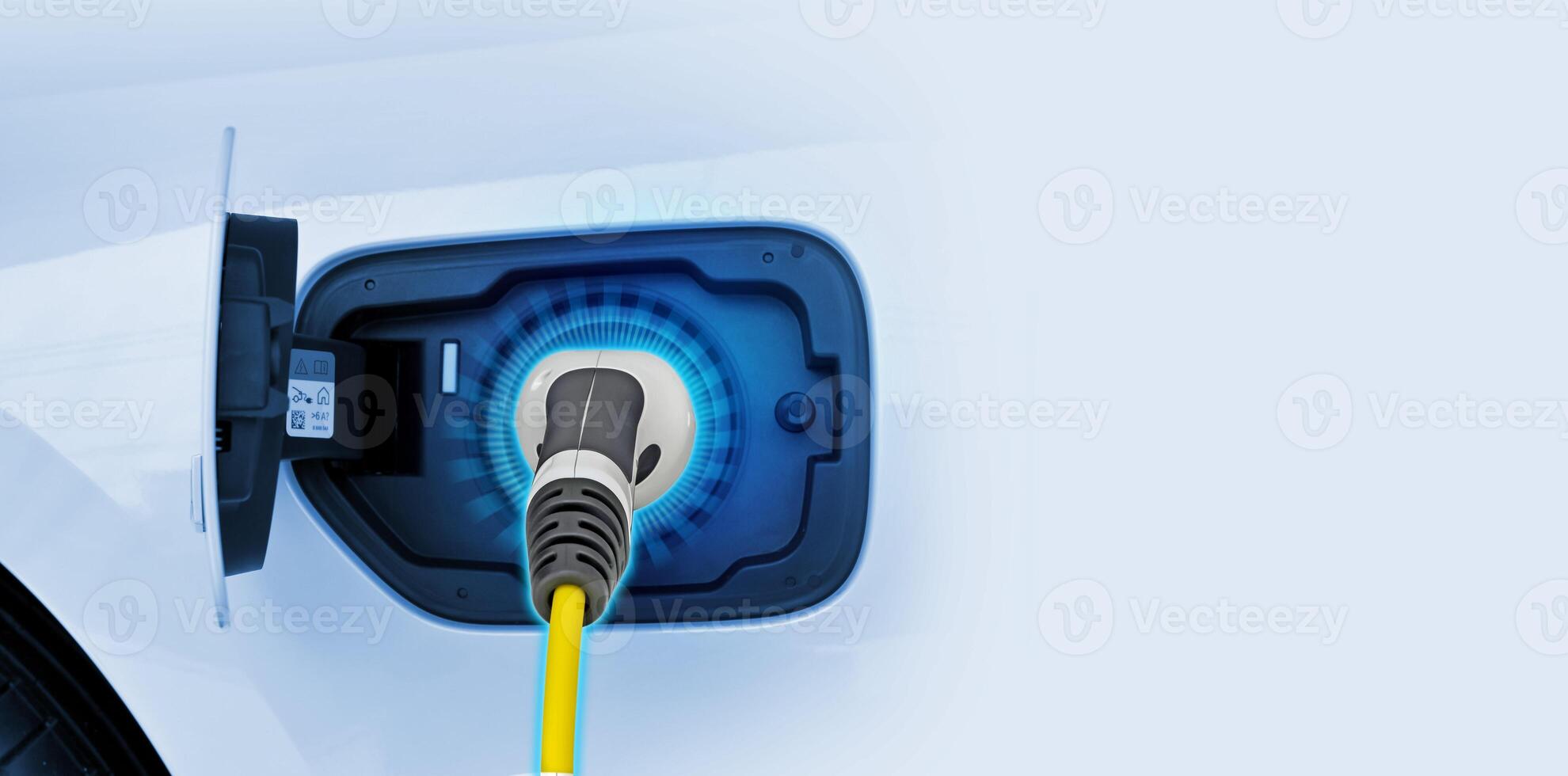 Power cable pump plug in charging power to electric vehicle EV car. photo