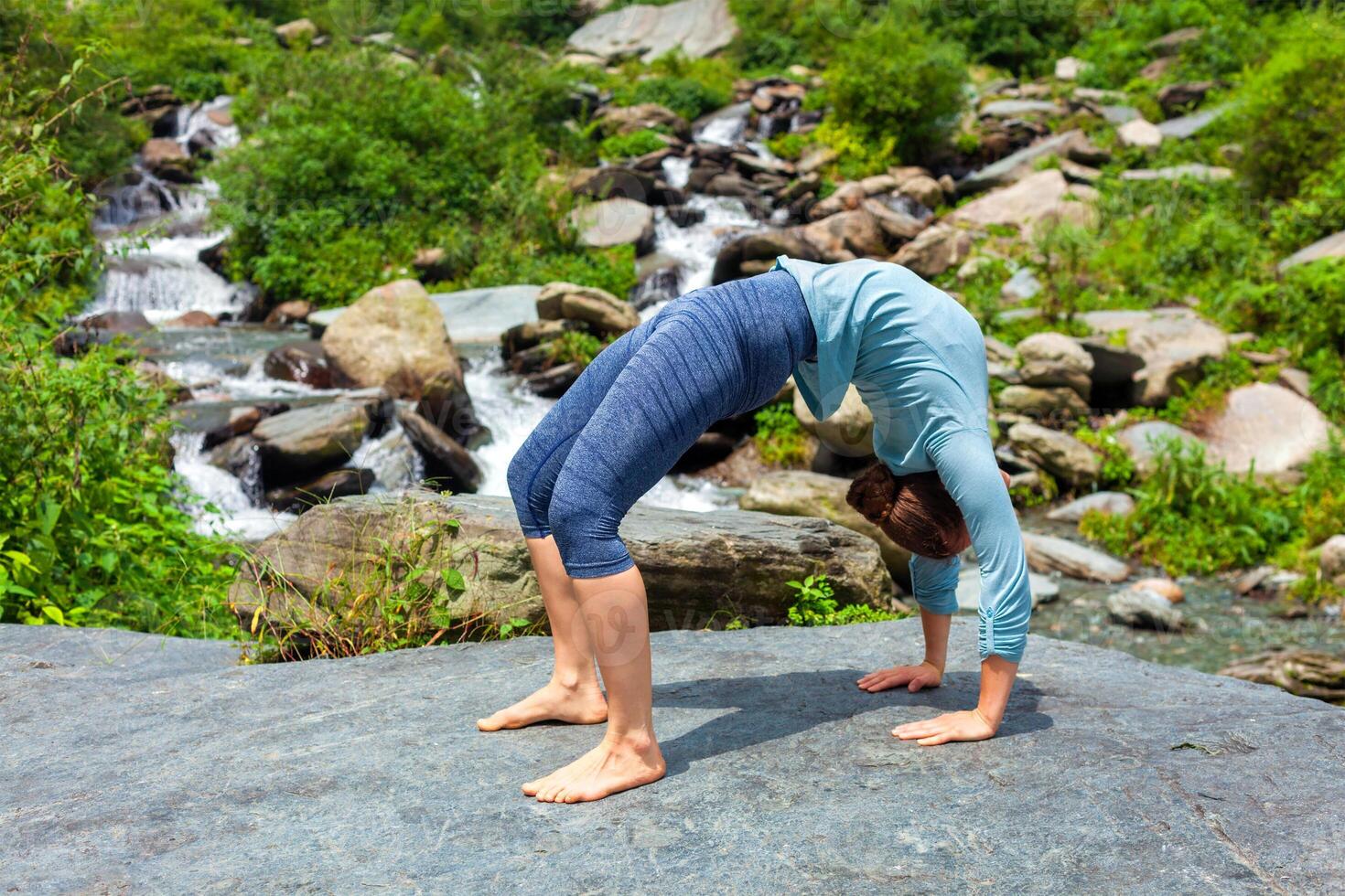Woman doing Ashtanga Vinyasa Yoga asana Urdhva Dhanurasana   up photo