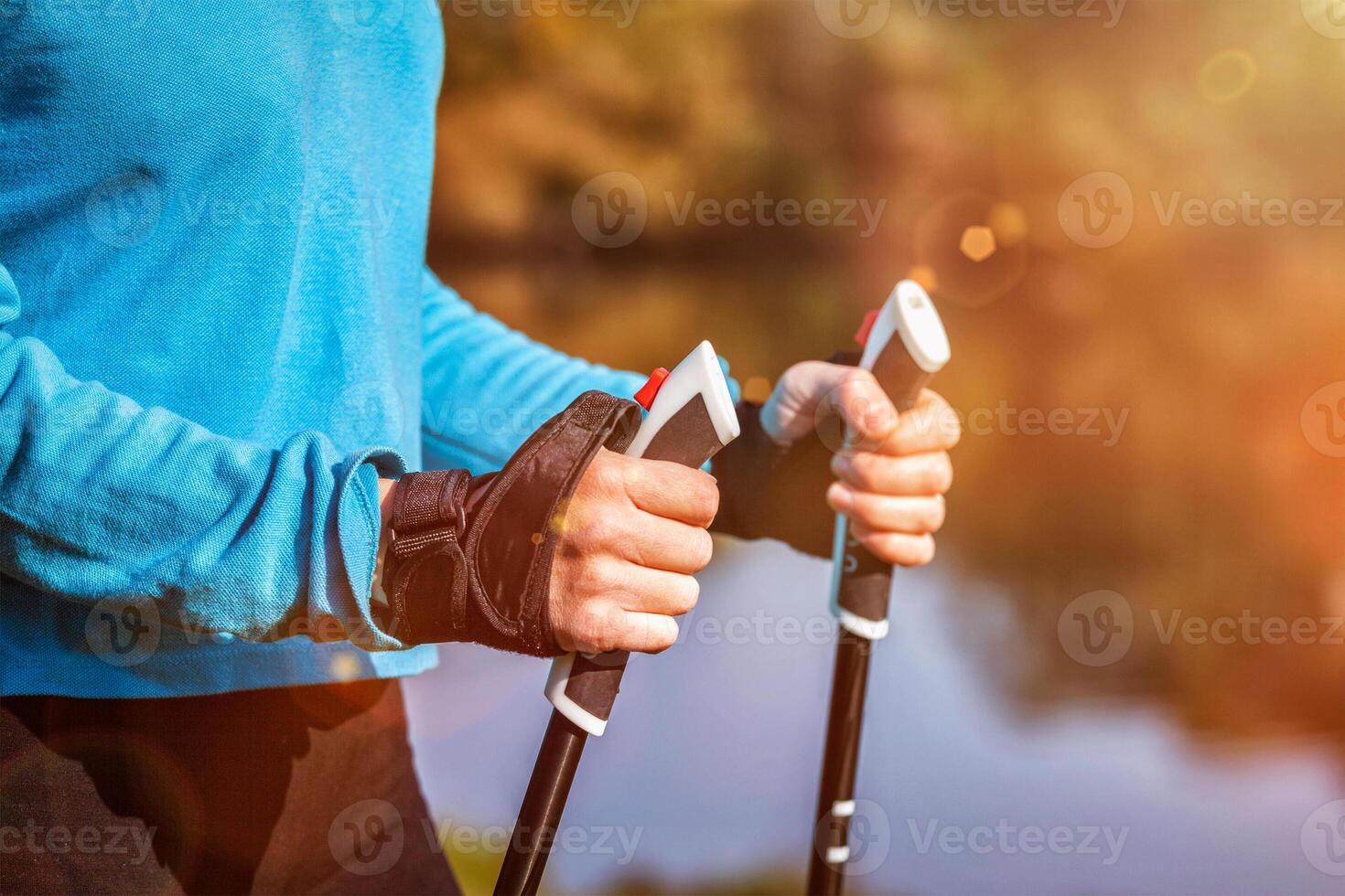 Closeup of woman's hand holding nordic walking poles photo