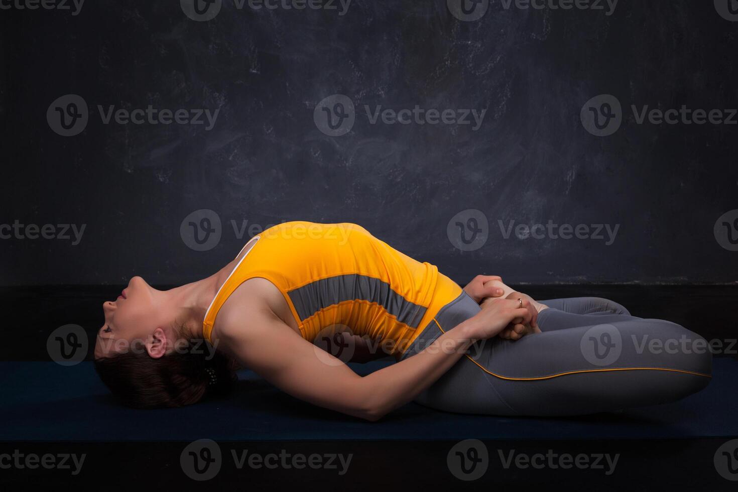 Beautiful sporty fit yogi girl practices yoga asana Matsyasana photo