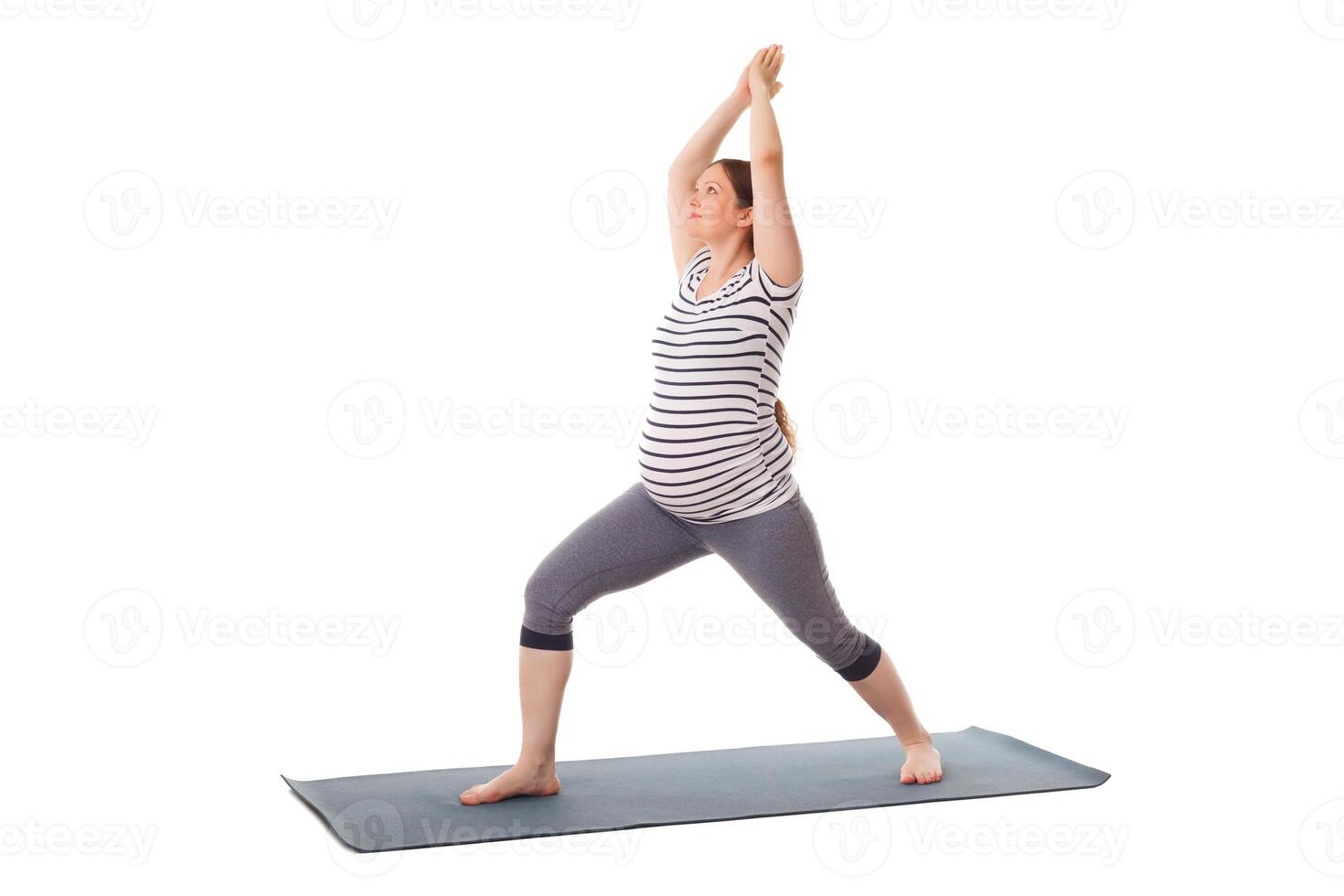 Pregnant woman doing yoga asana Virabhadrasana 1 photo