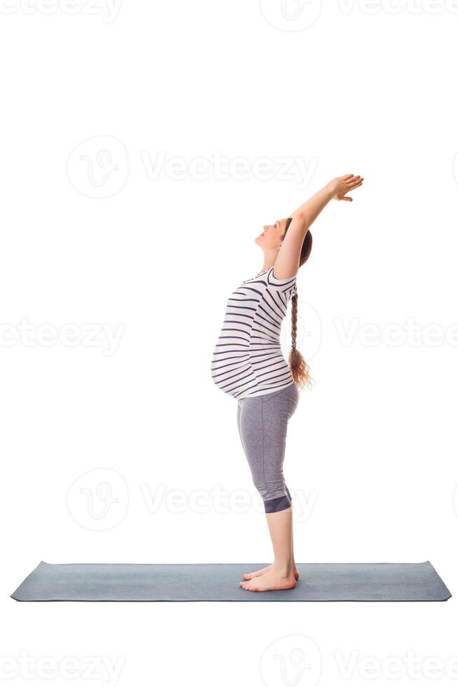 Pregnant woman doing yoga asana Tadasana Mountain pose photo