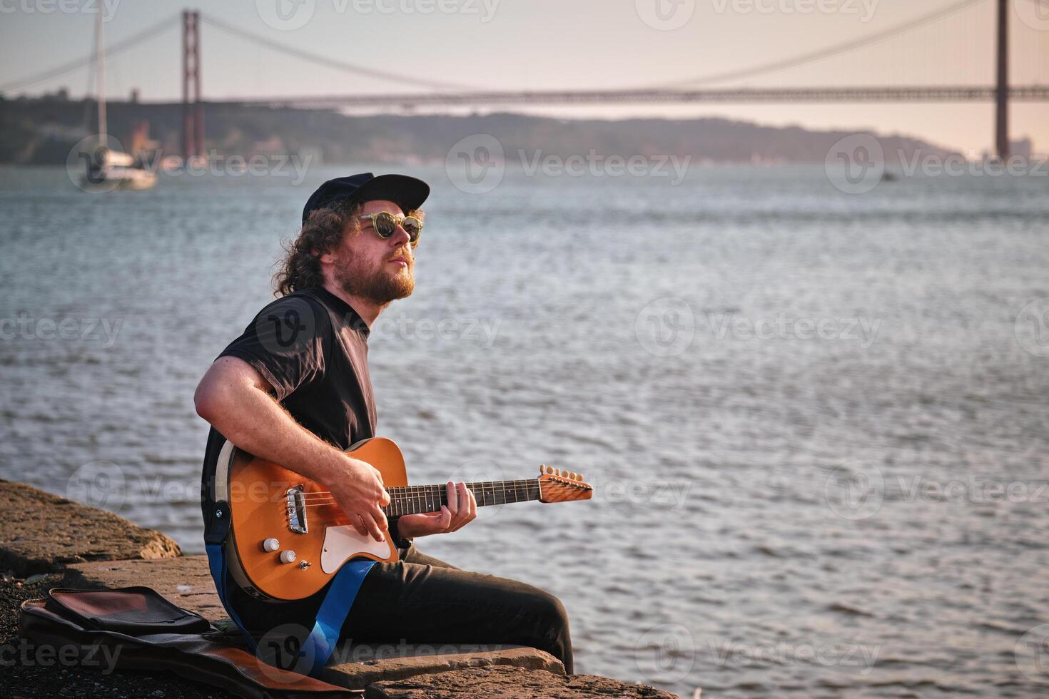 Street musician playing electric guitar in the street photo