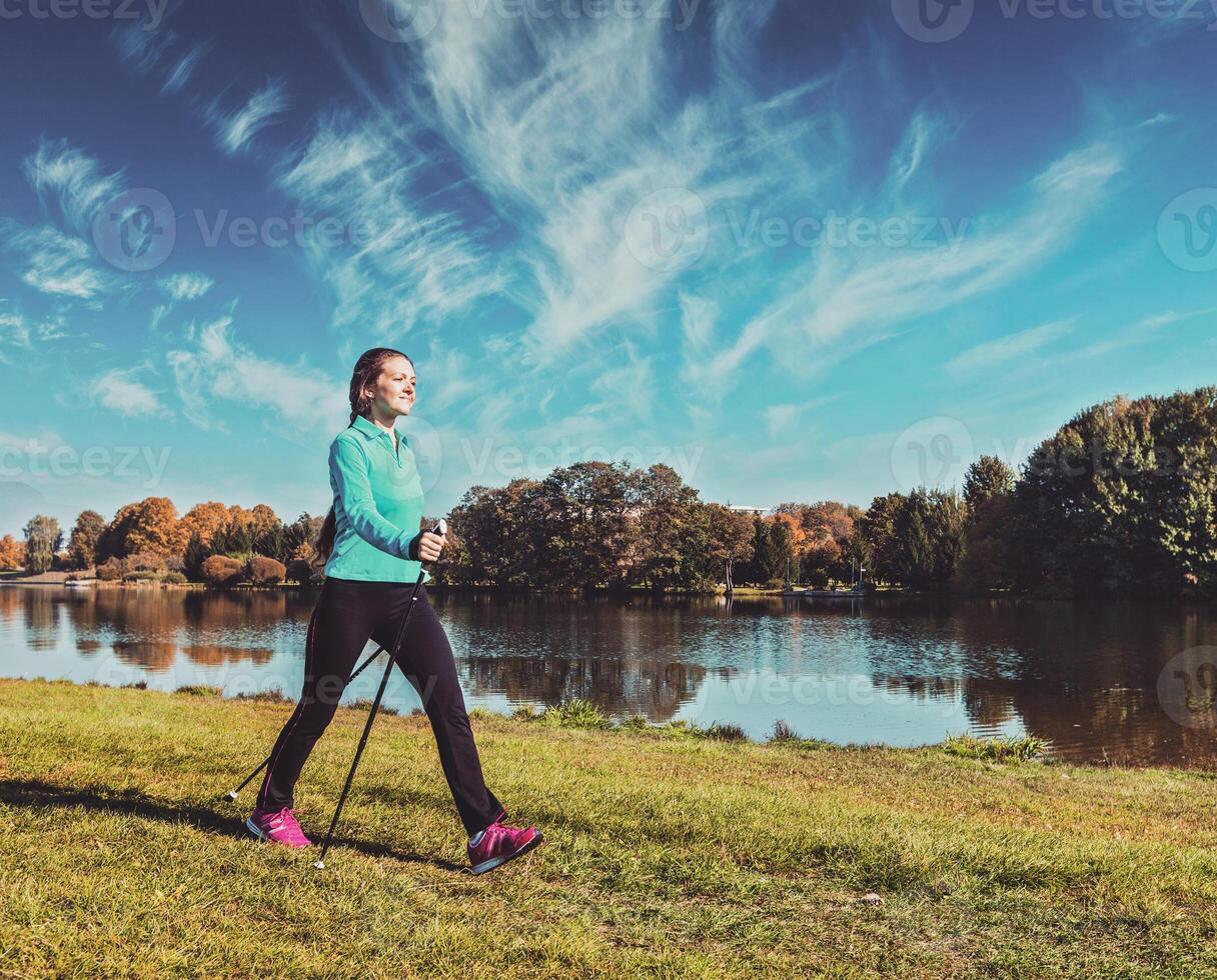 Young woman nordic walking photo