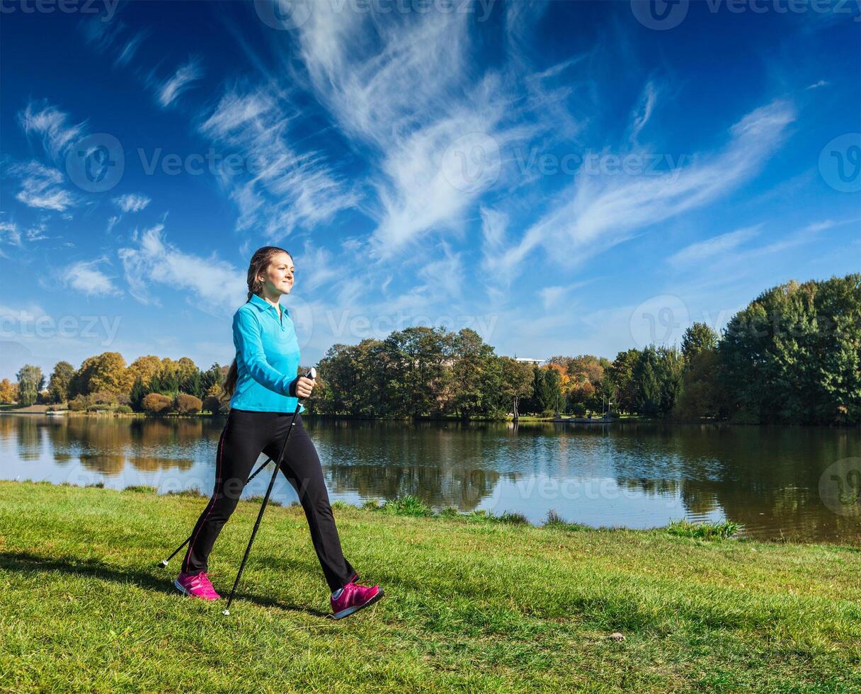 Young woman nordic walking photo