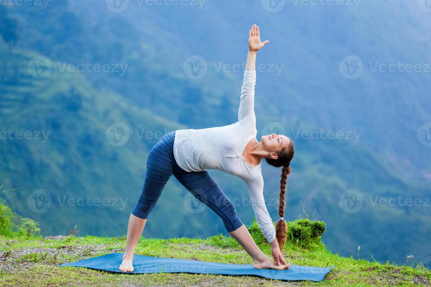 Woman doing Ashtanga Vinyasa yoga asana Utthita trikonasana photo