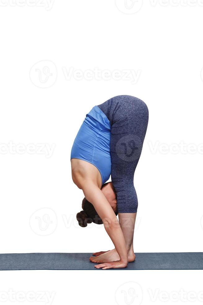 Woman doing yoga asana Uttanasana   standing forward bend photo